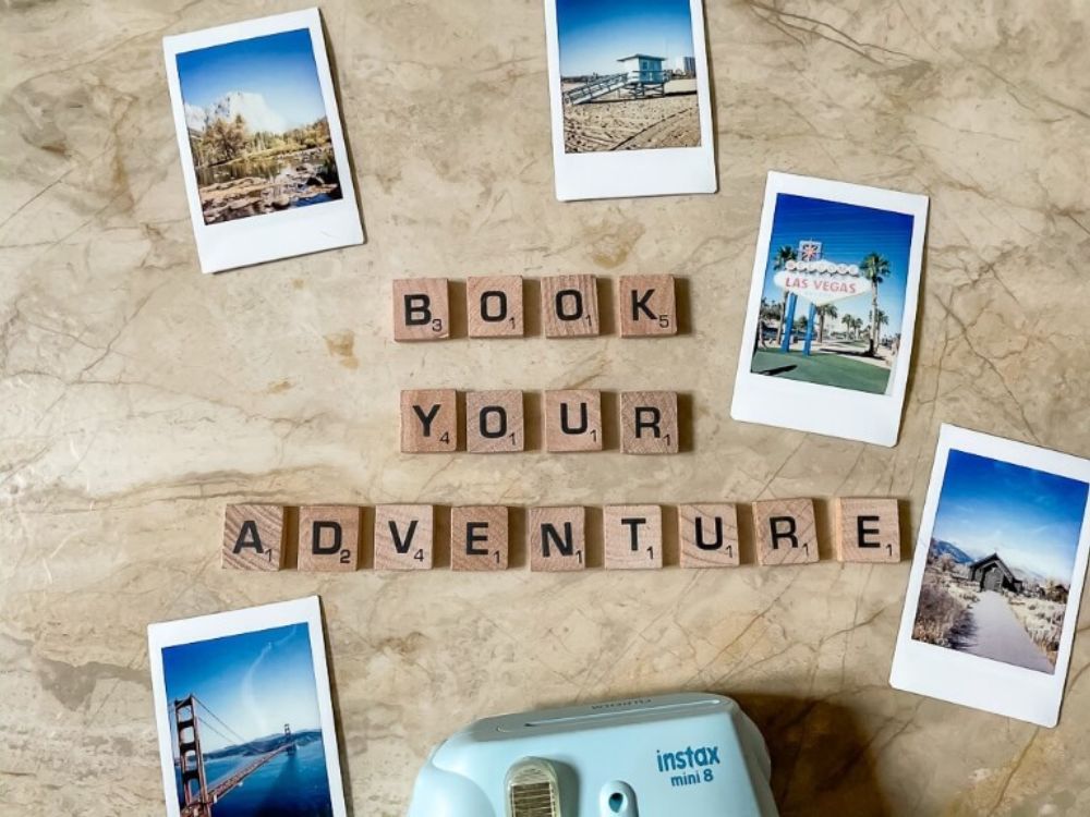 Small photos if various travel destinations surrounding a small blue instax camera to inspire trip planning