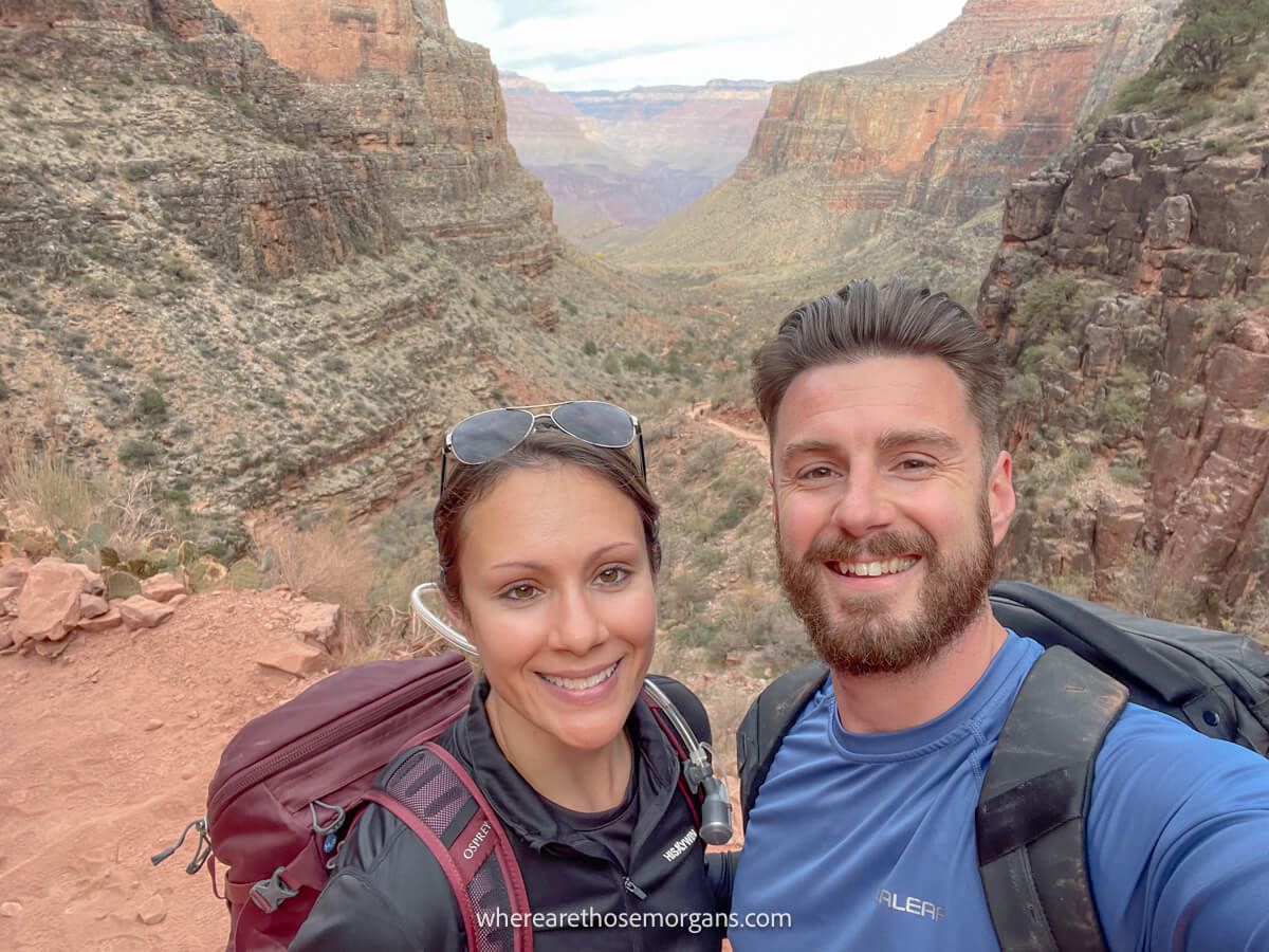 Photo of two hikers taking a selfie with backpacks on hiking at the Grand Canyon