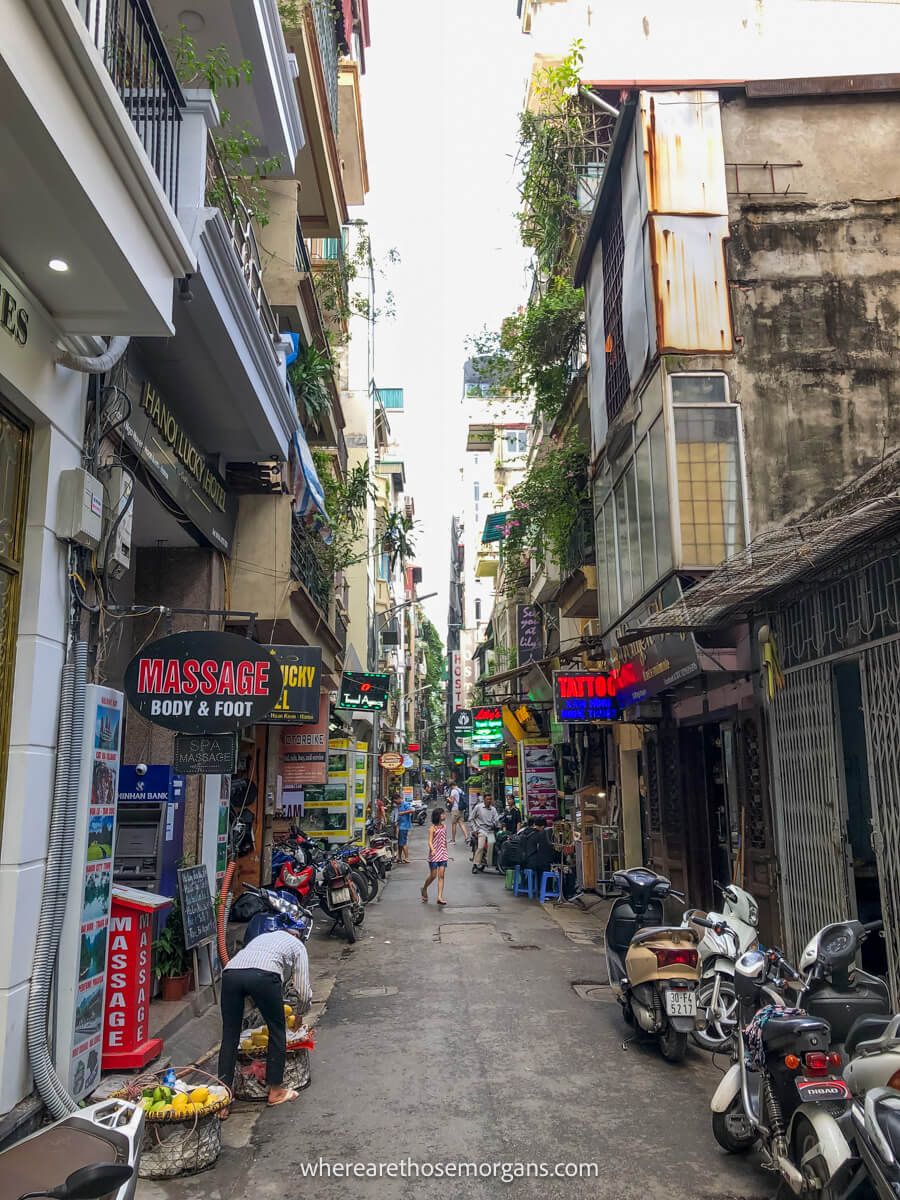 Street in Hanoi filled with shops and motorbikes