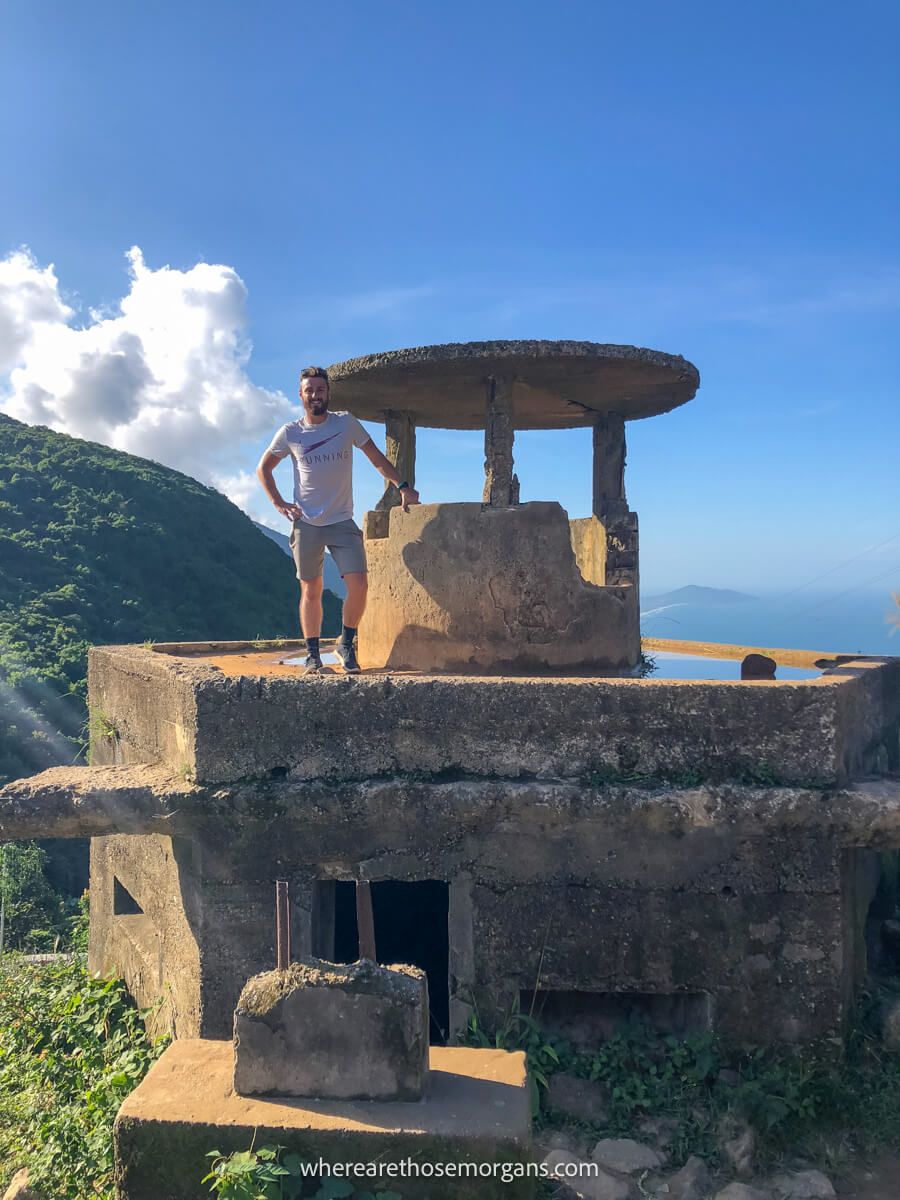 Person standing on a stone fortress at the summit of the Hai Van Pass