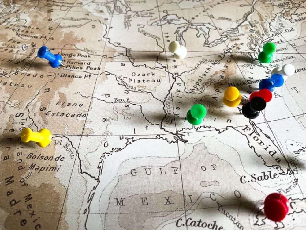Different colored pins on a map pointing to various travel destinations