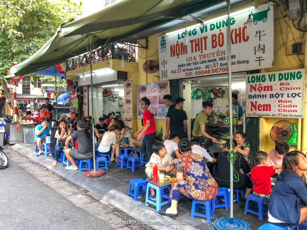 A local restaurant in Hanoi filled with people out front