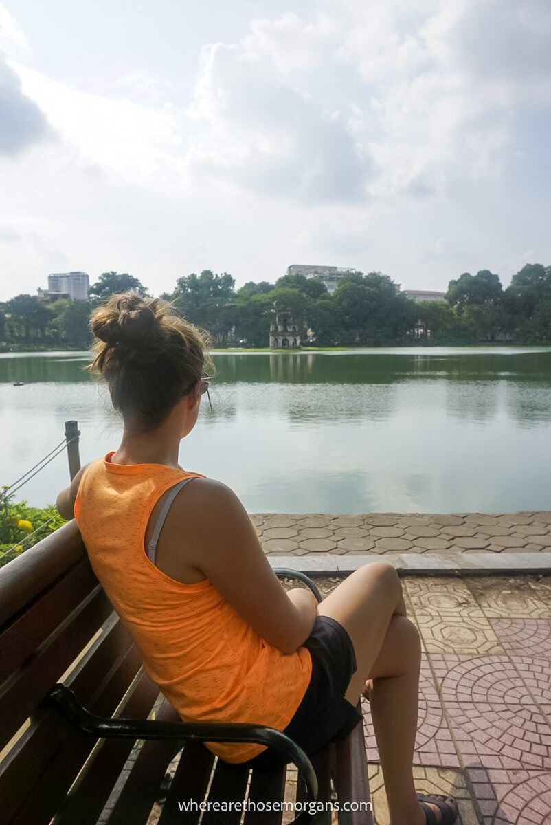 Woman sitting on a bench along Hoam Kiem Lake