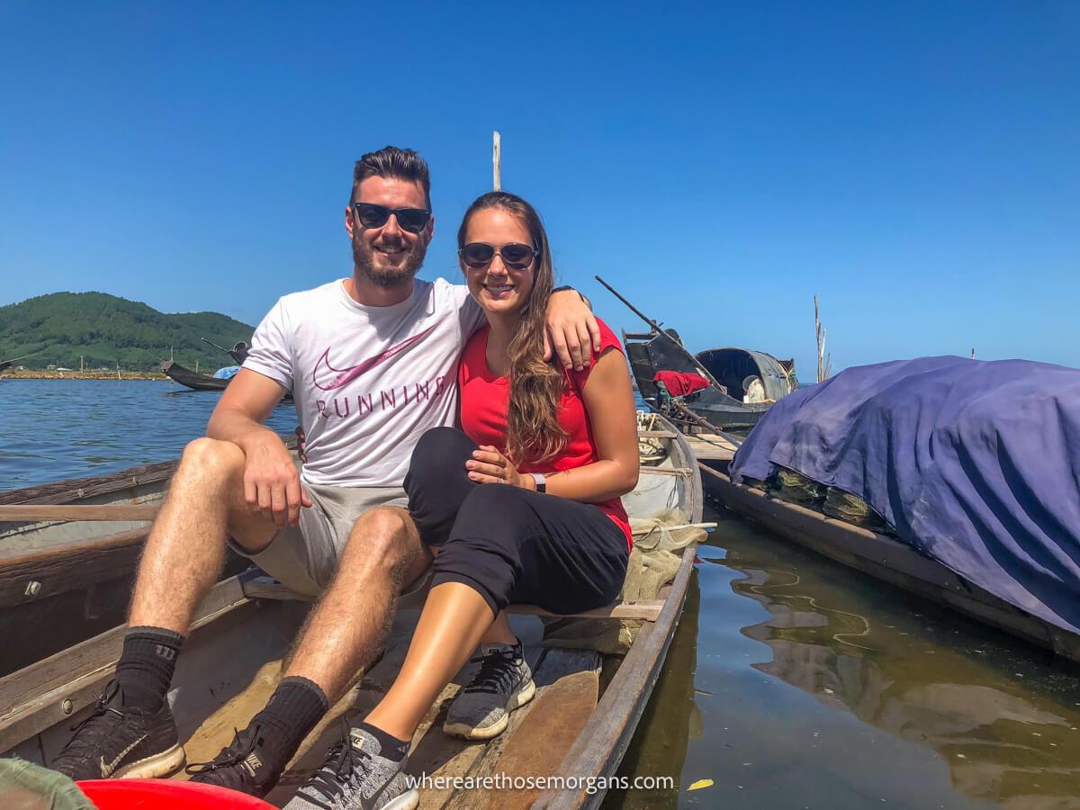 Two people sitting in a boat at Lang Co Beach