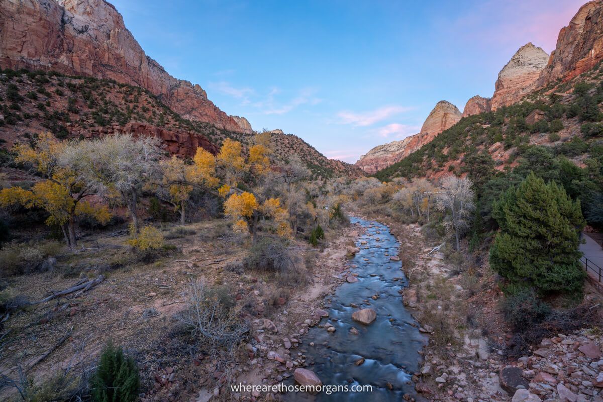 Photo of the Virgin River cutting through Zion's red rock landscape at sunset on the Pa'rus Trail hike