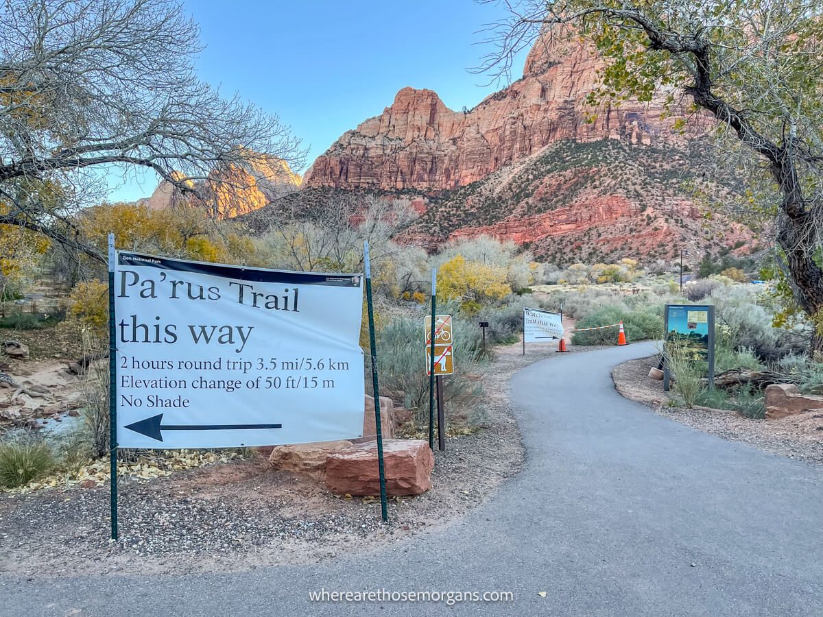 Photo of a white canvas trail sign pointing left in a red rock landscape in Utah