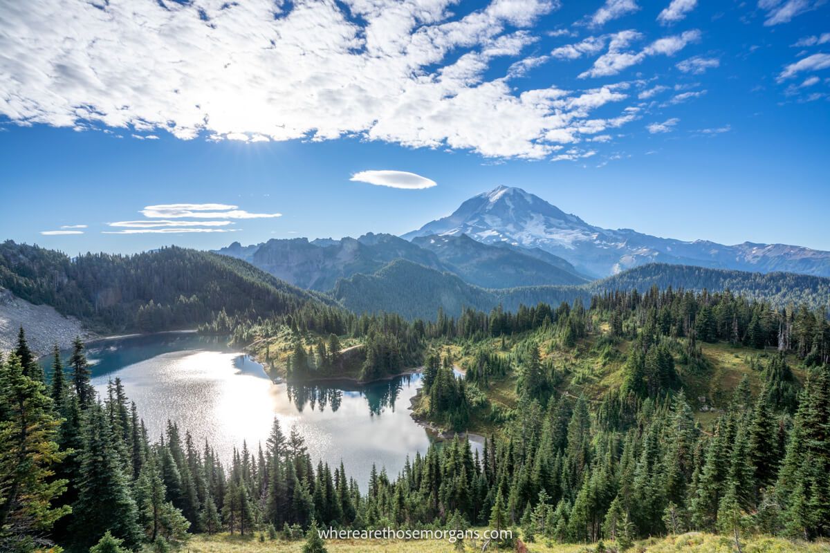 Photo of Eunice Lake and Mt Rainier in a wide open green landscape under a deep blue sky from the summit of Tolmie Peak Trail