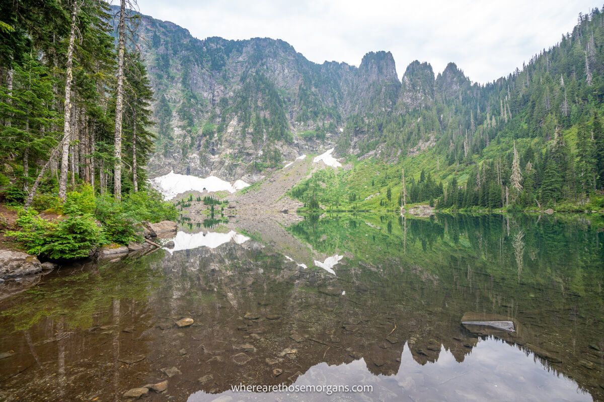 Photo of a perfectly still Lake 22 in Washington reflecting trees, mountains and snow