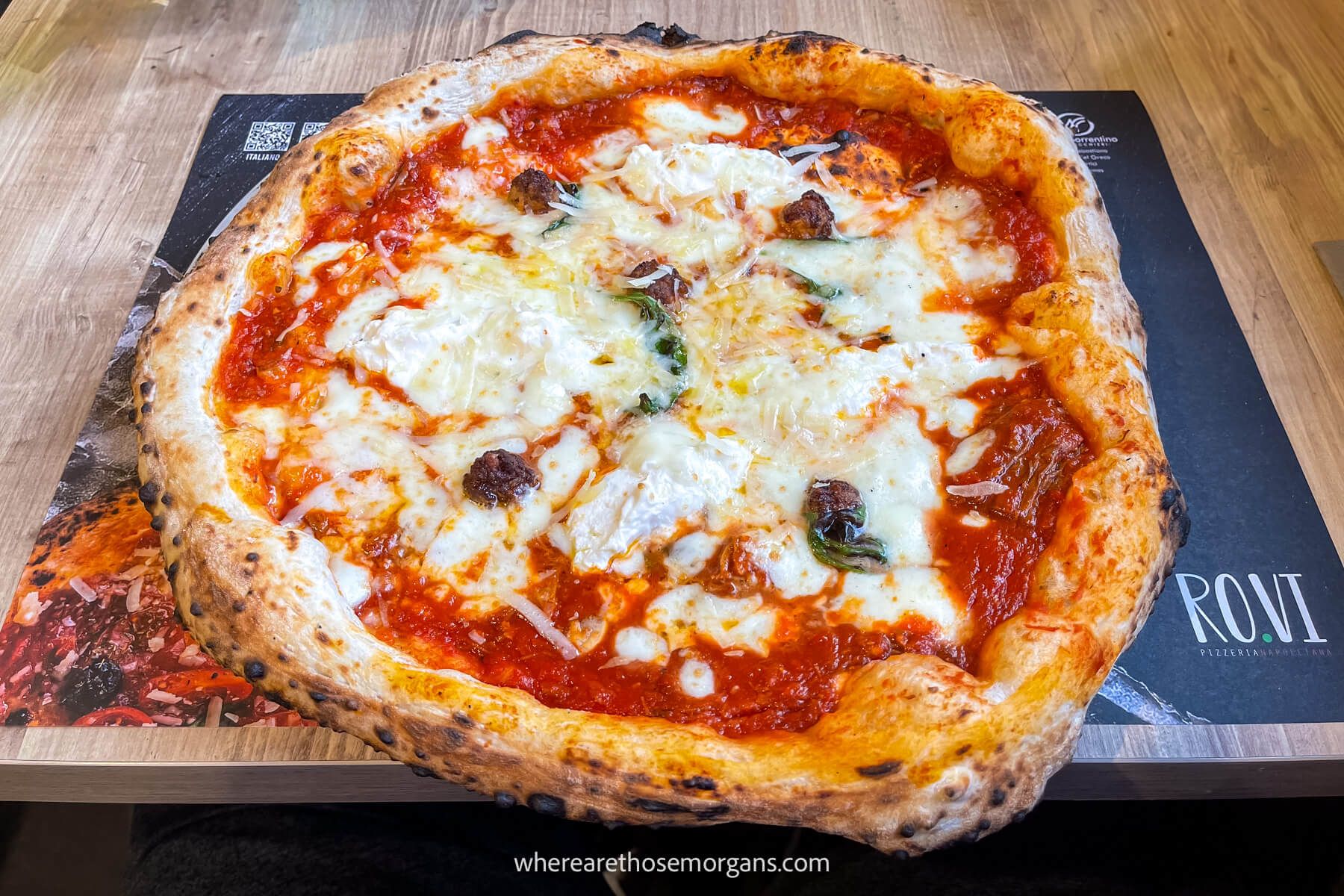 Photo of an authentic Neapolitan pizza with cheese and tomato on a table setting