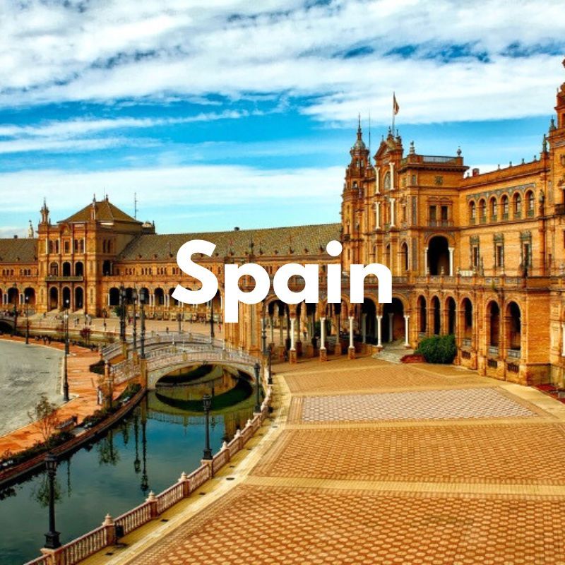 Photo of a plaza and buildings curving next to a waterway at sunset with the word Spain overlaid