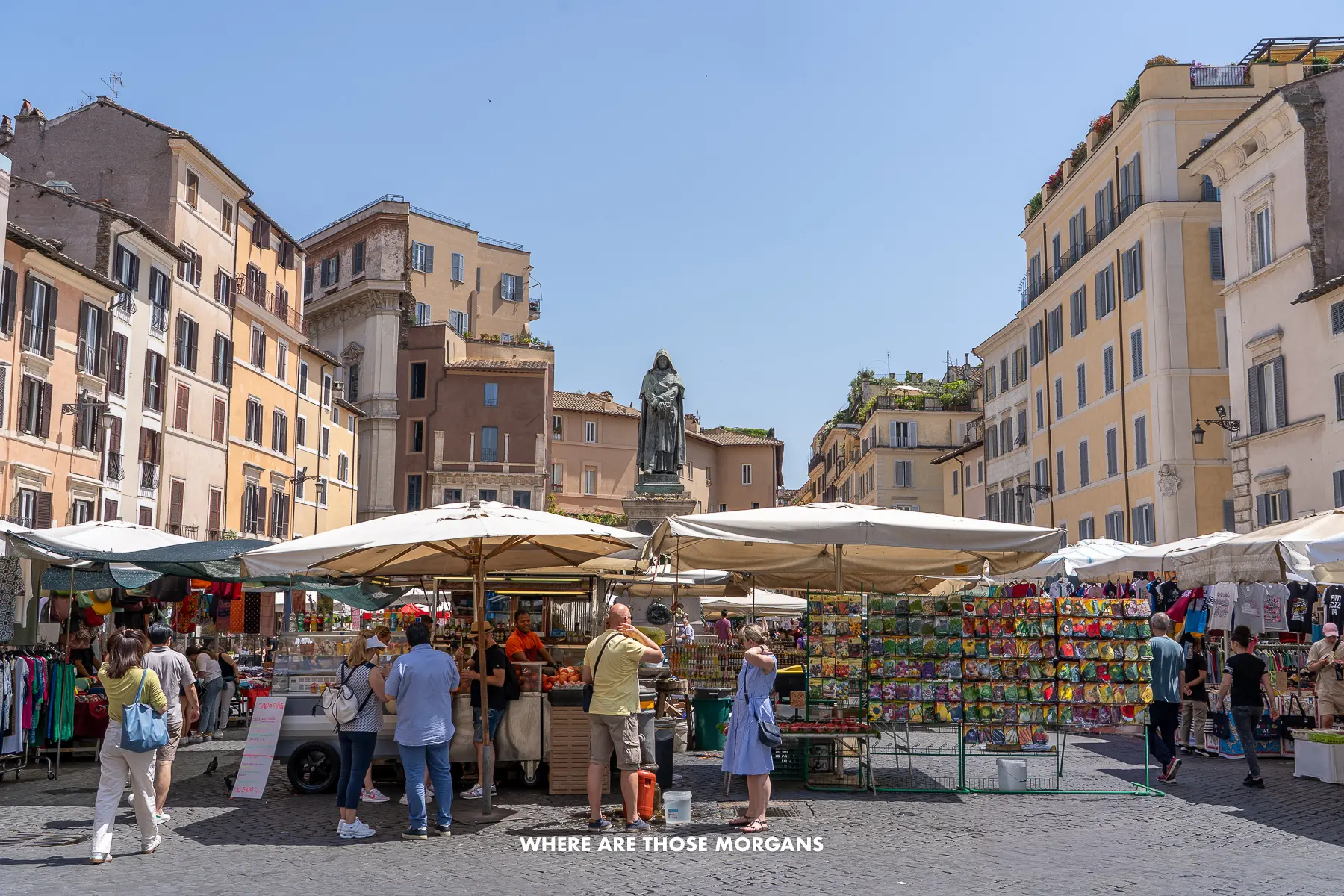 People working and browsing food stalls in a market in Italy