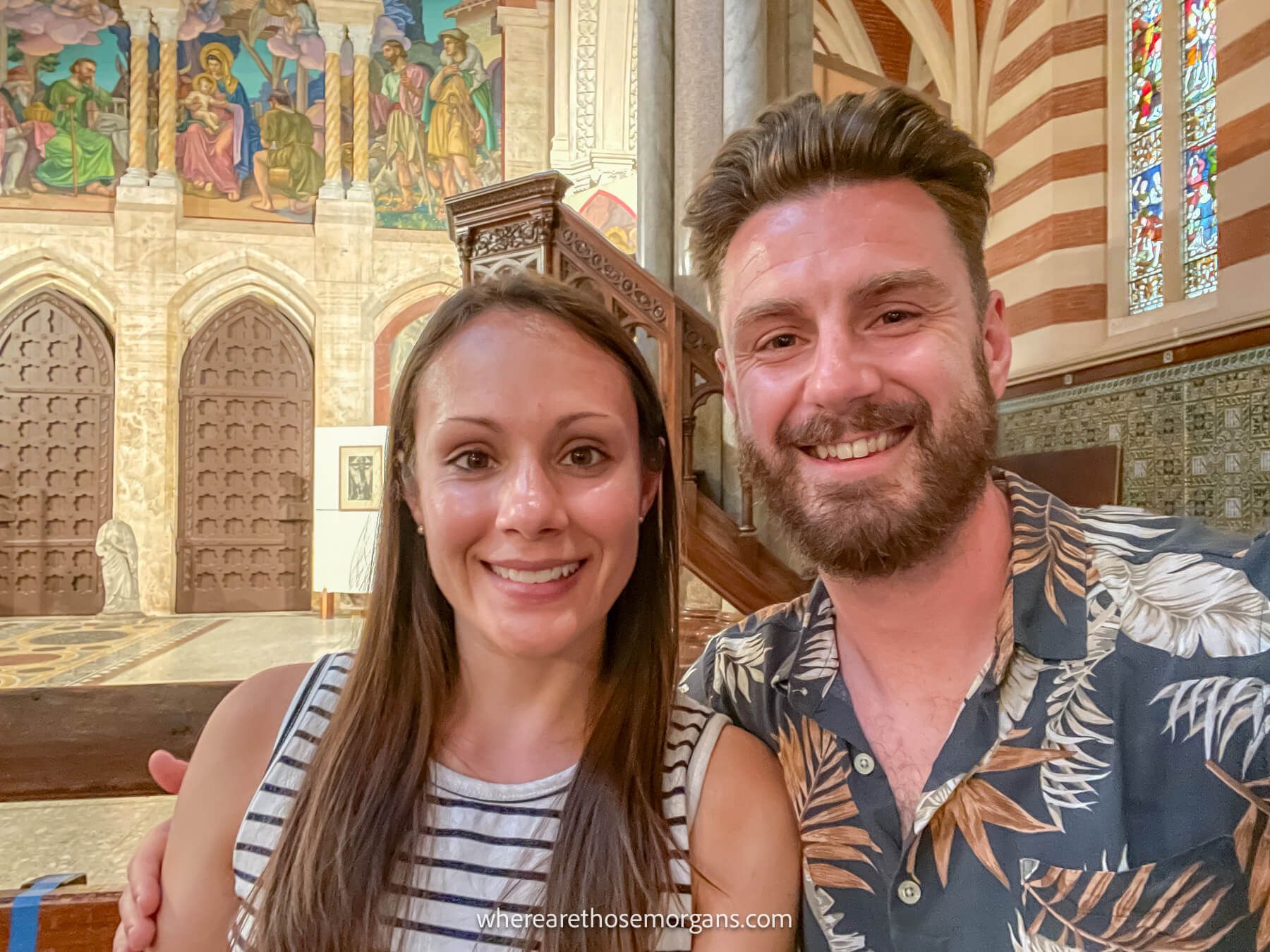 Photo of Mark and Kristen Morgan from Where Are Those Morgans taking a selfie inside a church at a classical music performance on a trip to Rome, Italy