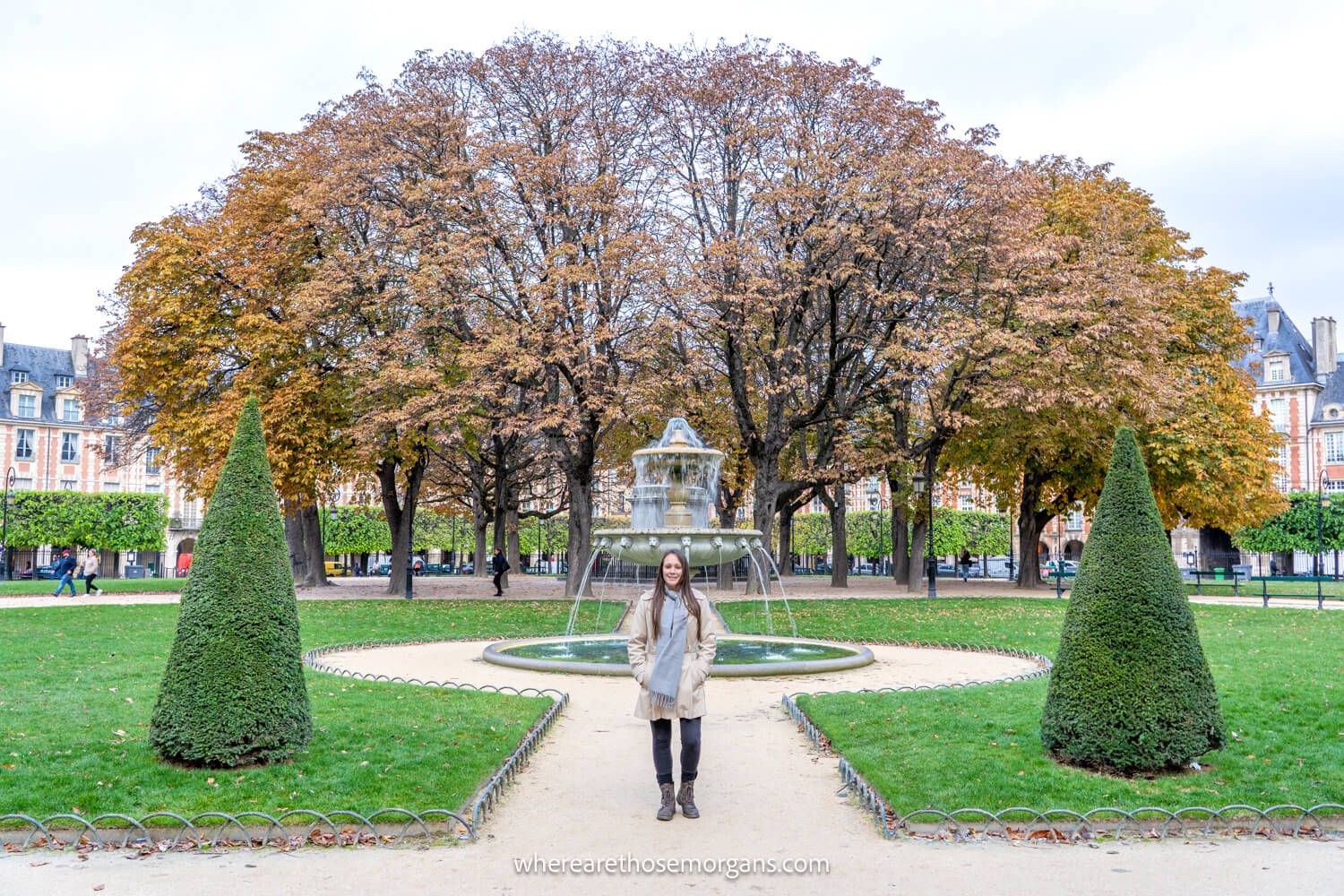 Photo of Kristen Morgan in a garden with trees, fountain and grass in France