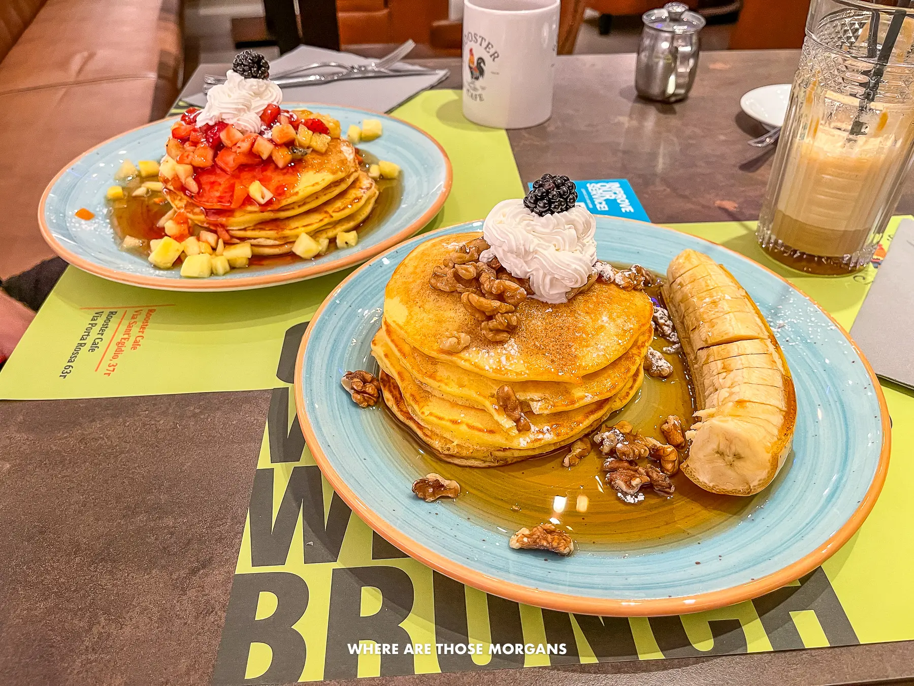 Plates of pancakes with fruit and syrup on a table in Italy