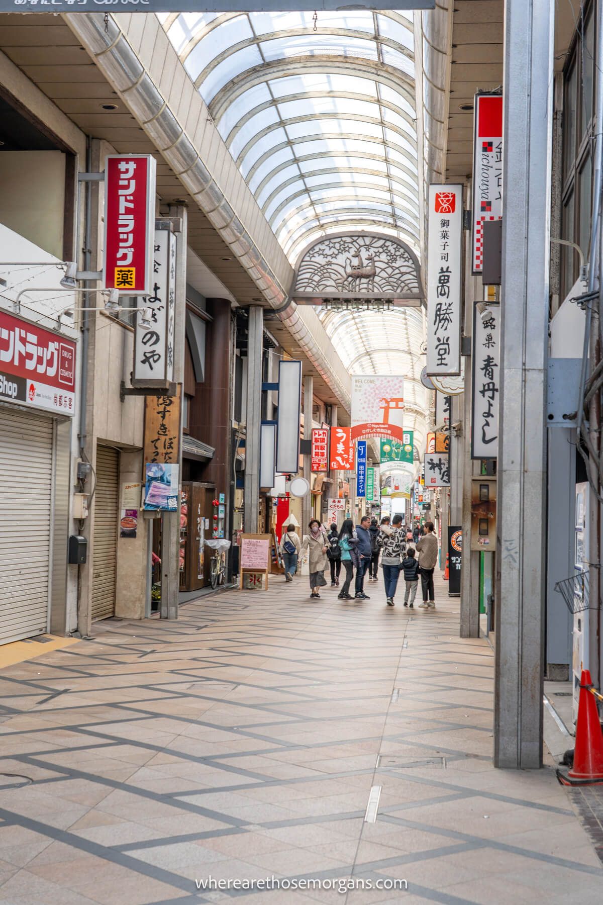 Photo of a covered pedestrian shopping street in Nara Japan with lots of people walking through