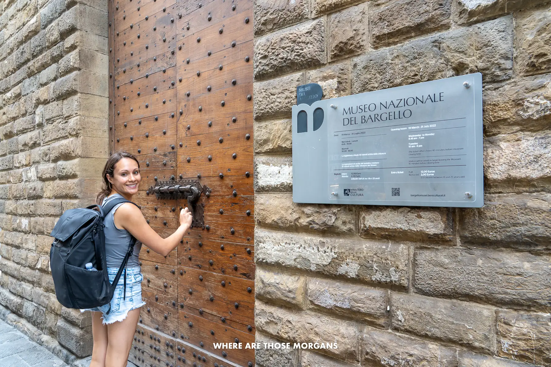 Kristen from Where Are Those Morgans entering a museum's wooden door in Florence, Italy