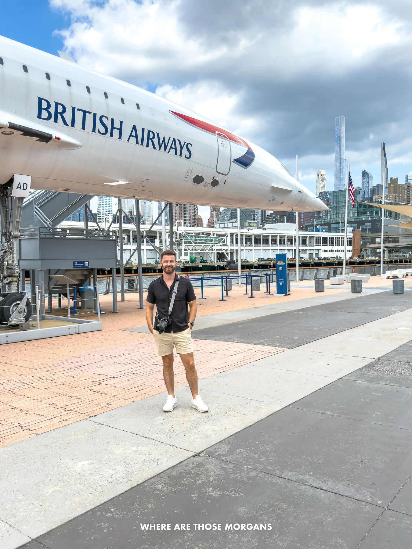 Photo of a tourist stood underneath a British Airways concord on Intrepid