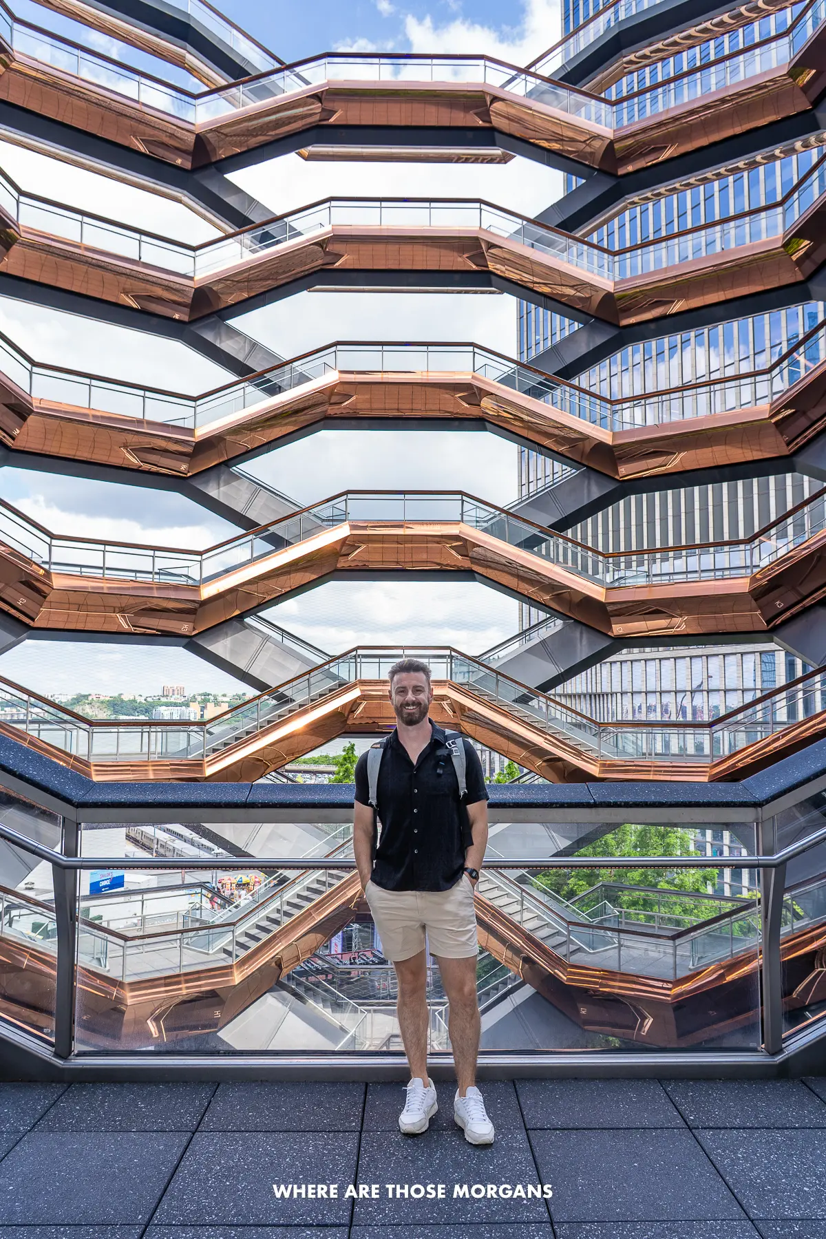 Photo of a tourist stood on the steps inside Vessel in NYC with nobody else around