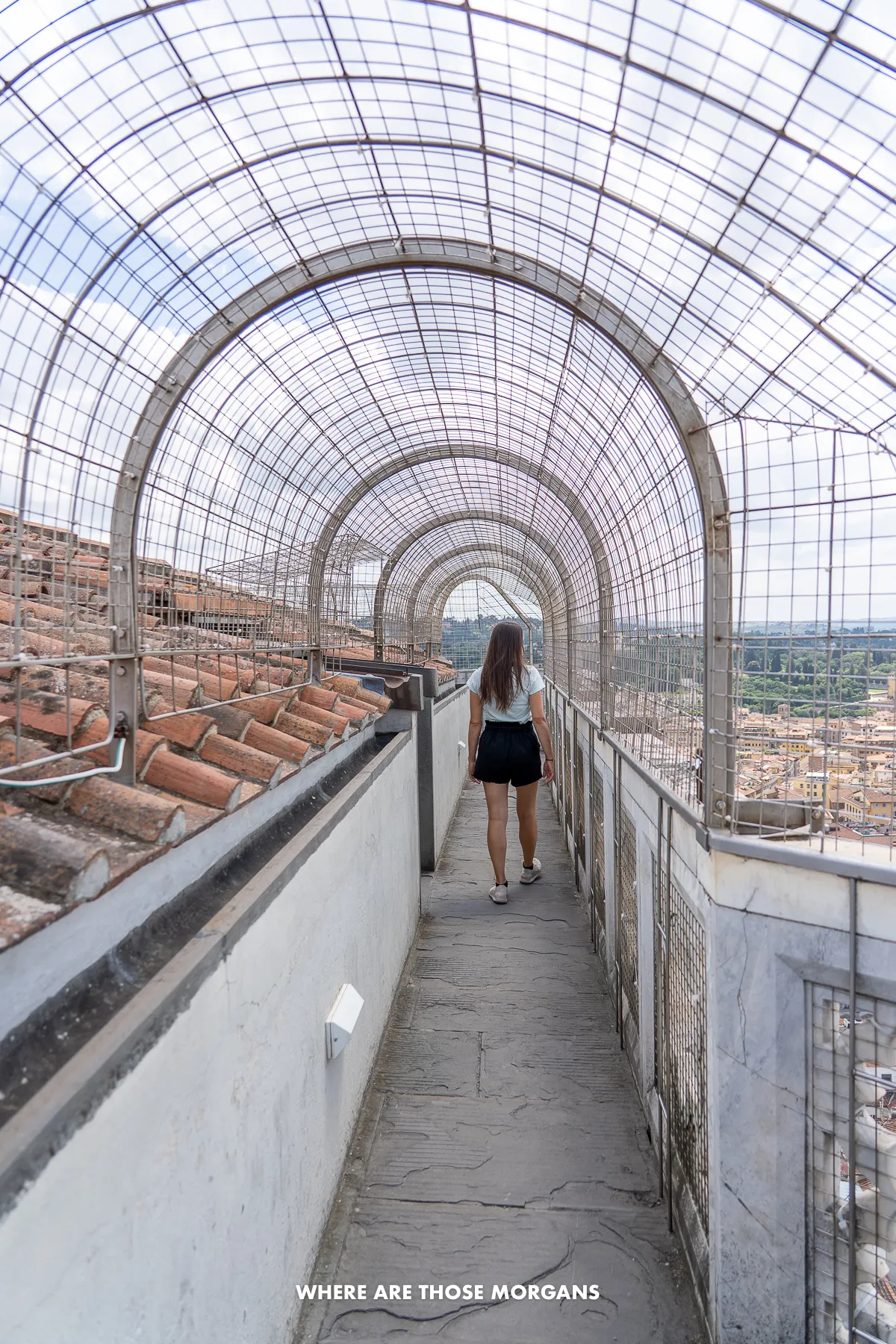 Photo of a tourist walking around the top of Giotto's Bell Tower