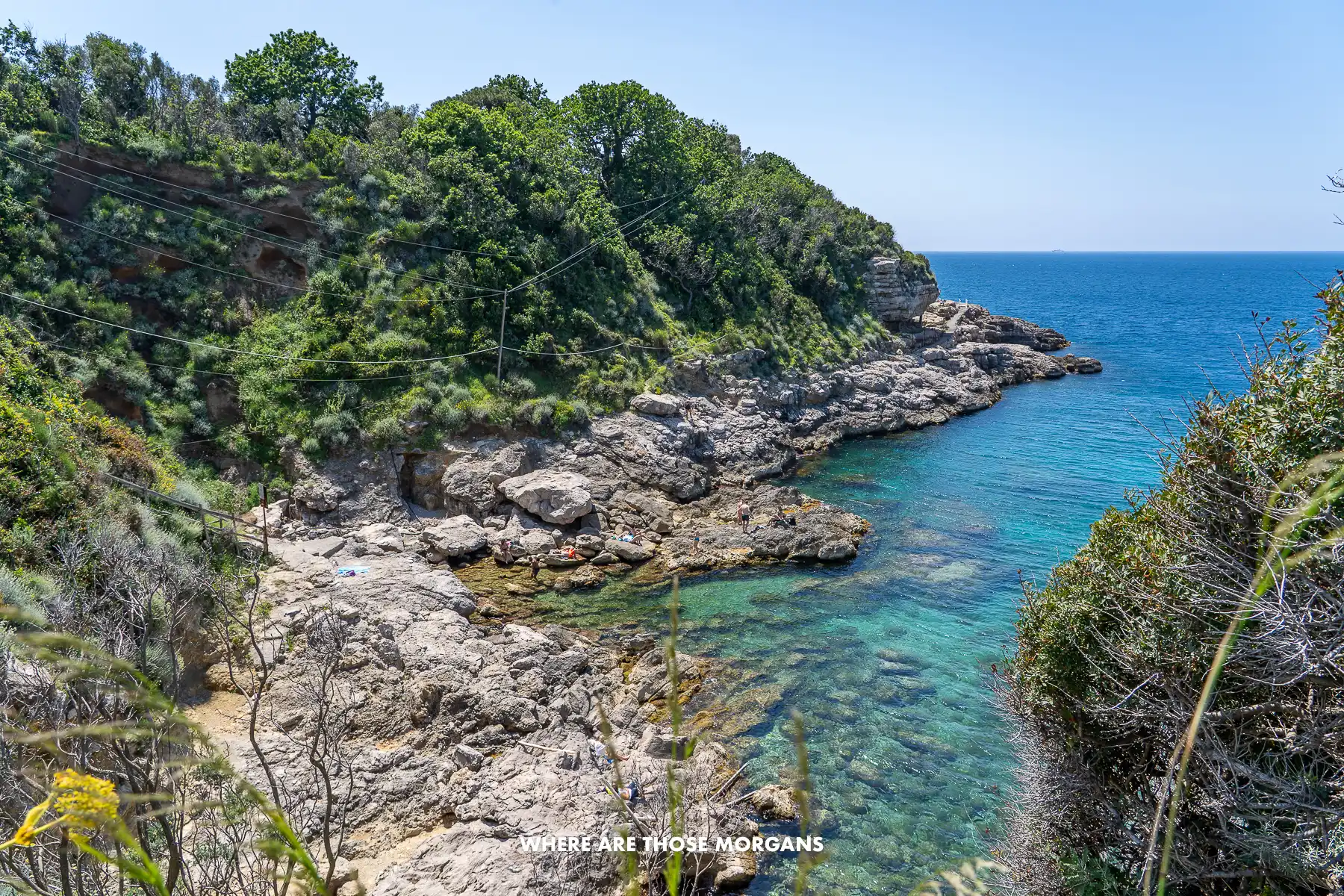 Photo of the rocky coastline at Capo di Sorrento on a clear sunny day with turquoise water