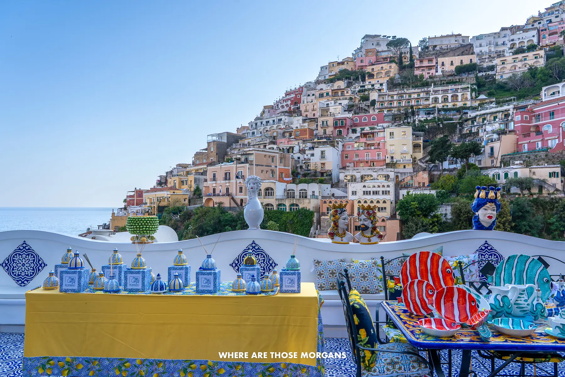 Photo of ceramic items for sale on a terrace with views over Positano behind