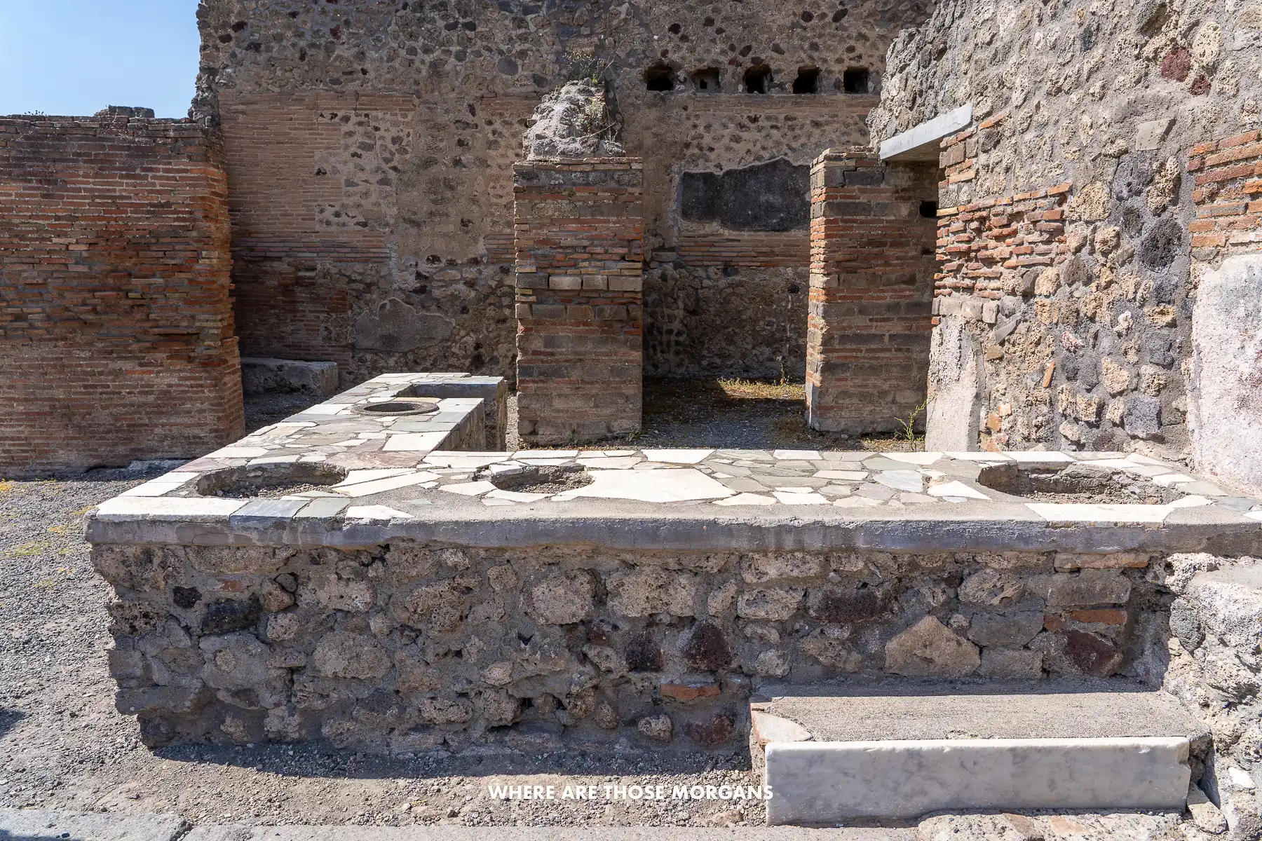Photo of an L-shaped ancient food market in the ruins of Pompeii Italy