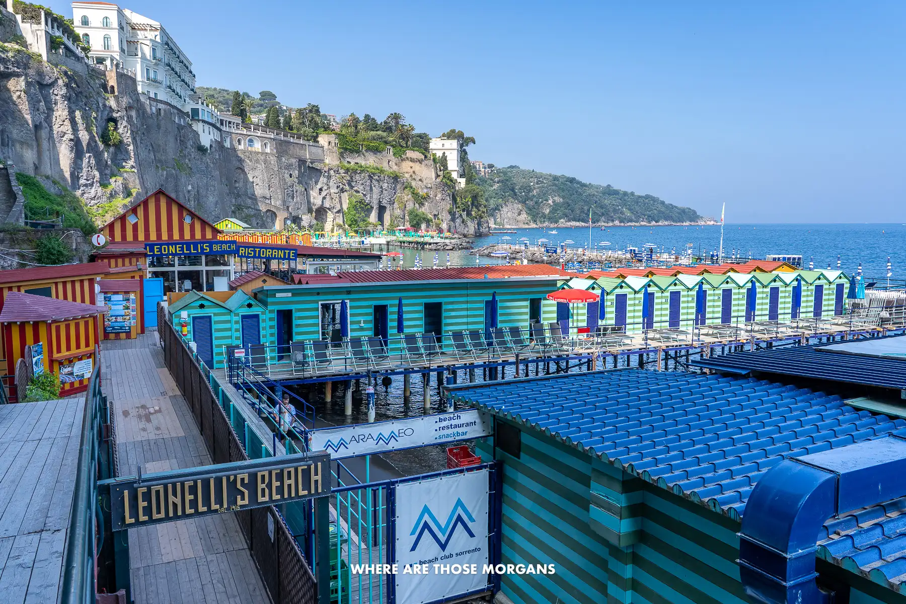 Photo of changing rooms and wooden piers with sun loungers next to a restaurant in Sorrento
