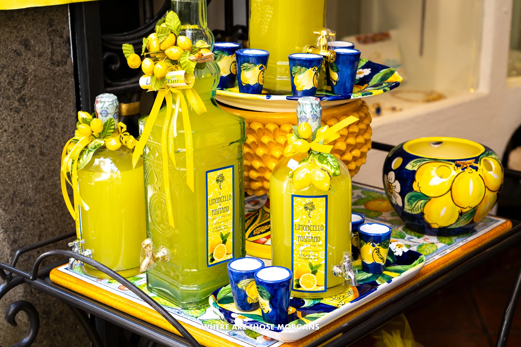 Photo of bottles of yellow Limoncello liqueur on a tray in a shop on the Amalfi Coast