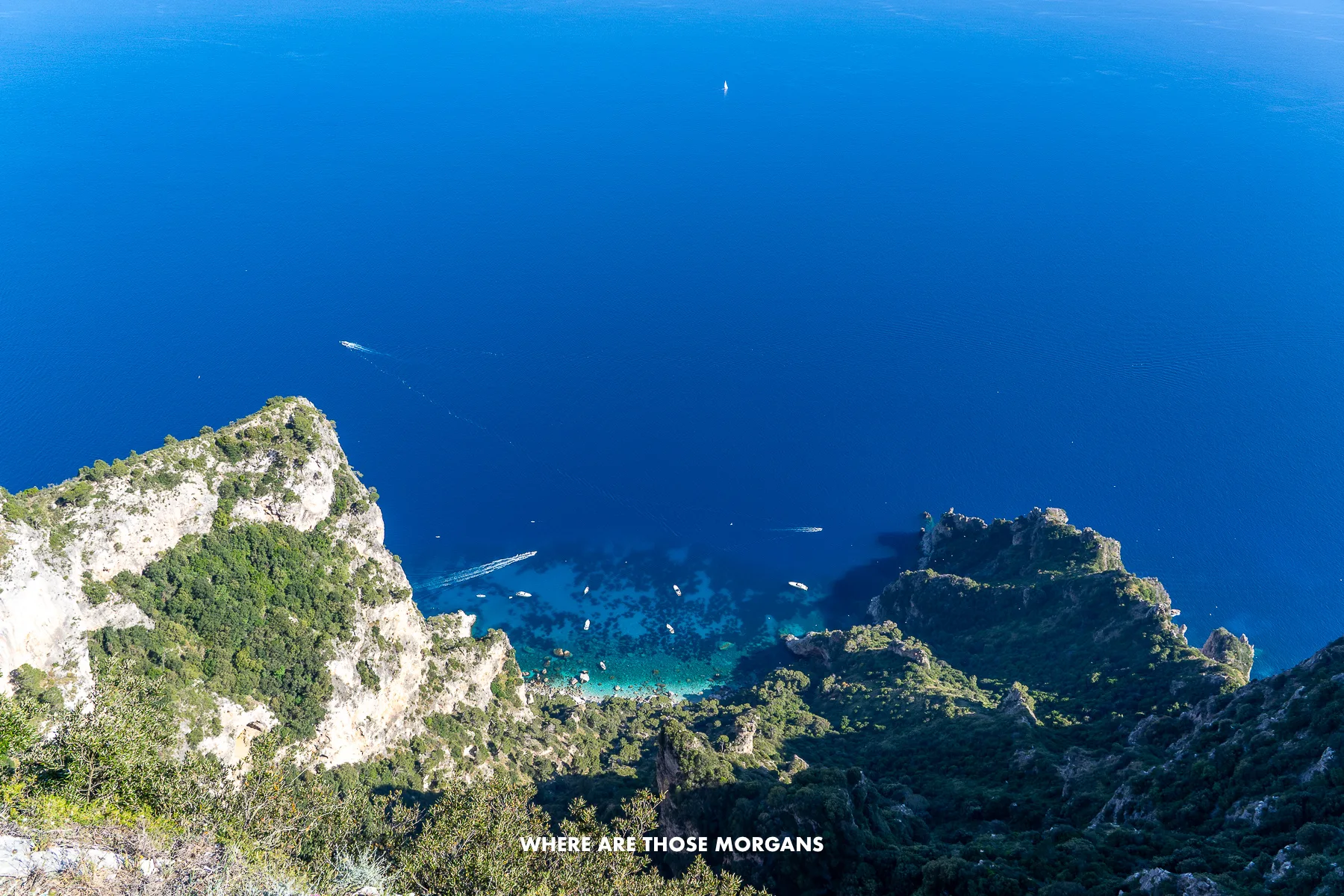 Photo of a view looking down at the sea and cliffs of Capri from the highest point on the island