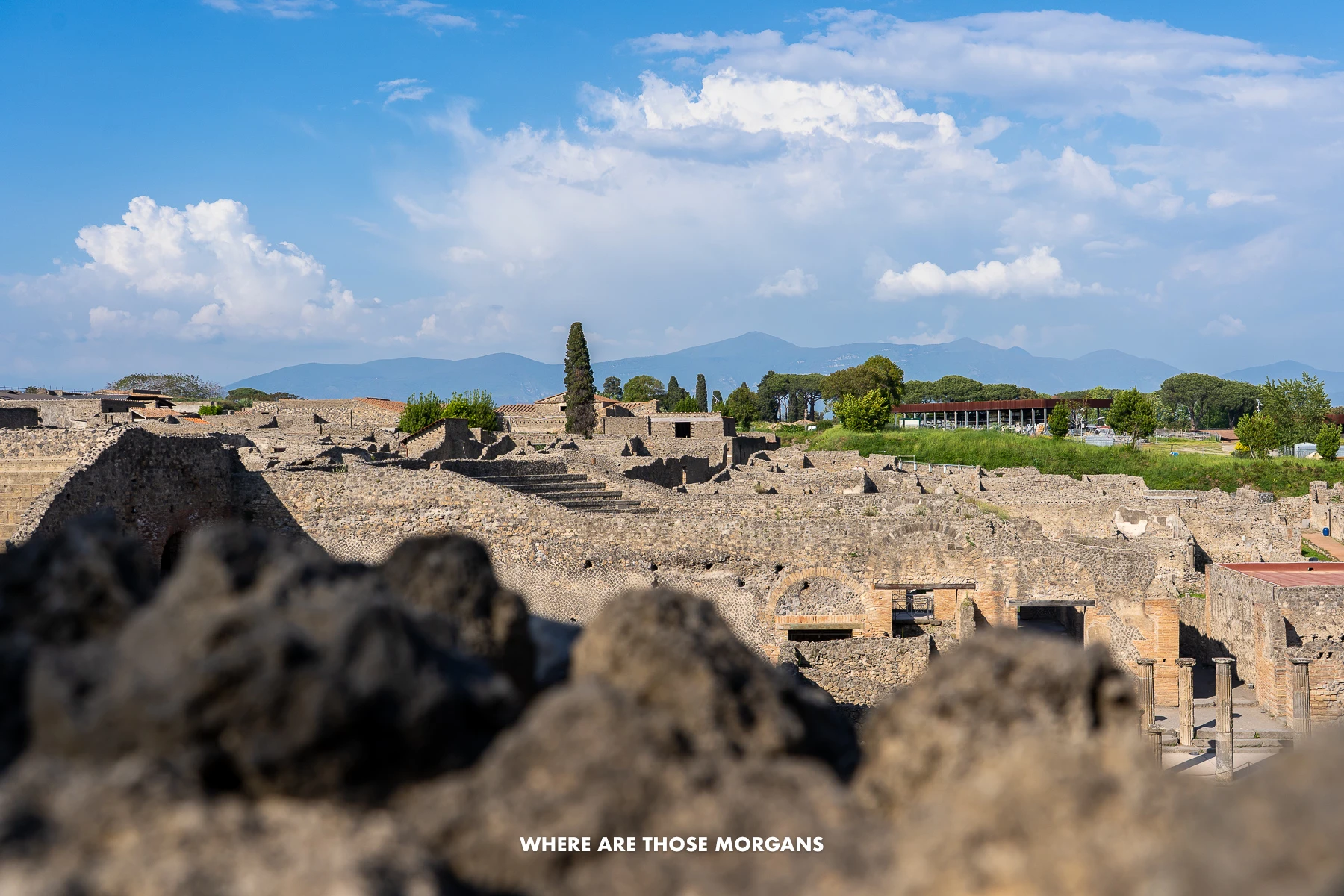 Photo of Pompeii ruins buildings from an elevated vantage point looking down over the town
