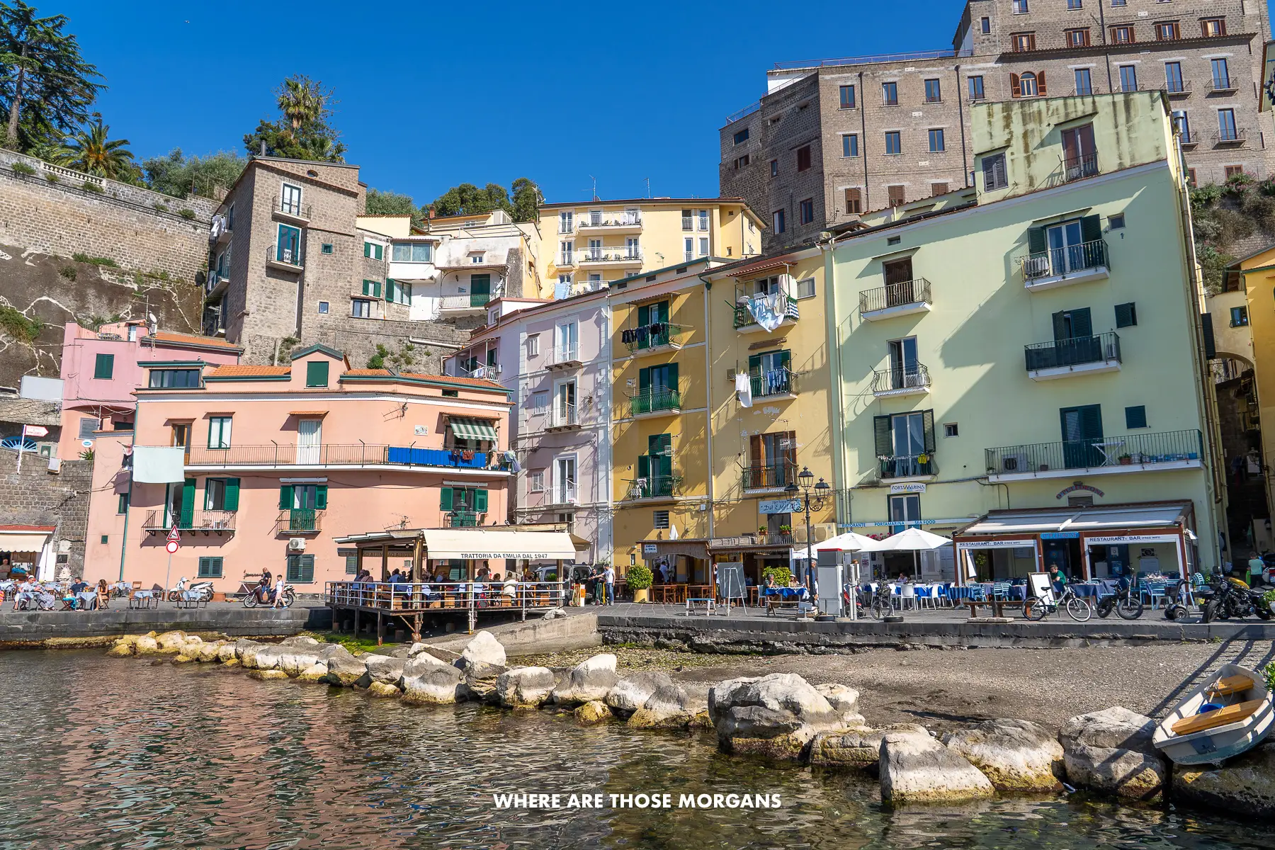 Photo of colorful buildings next to a bay in Italy