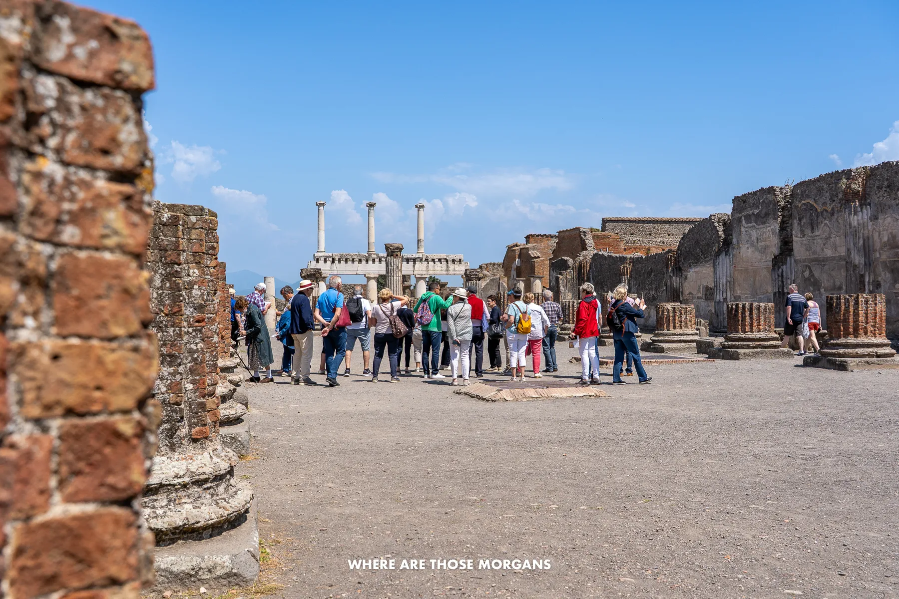 Photo of tourists in a group tour inside Pompeii ruins in Italy