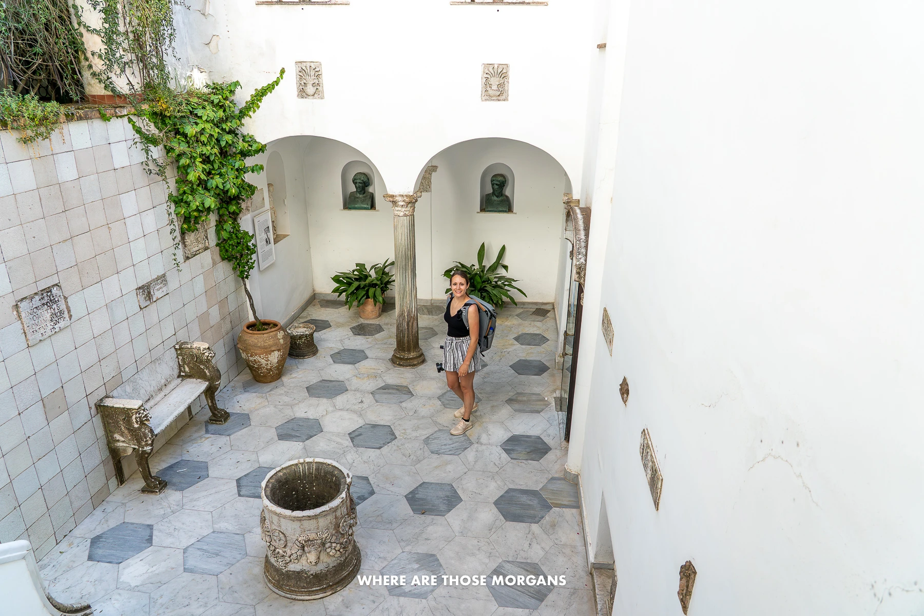 Photo of Kristen Morgan from Where Are Those Morgans walking through a villa courtyard with plants