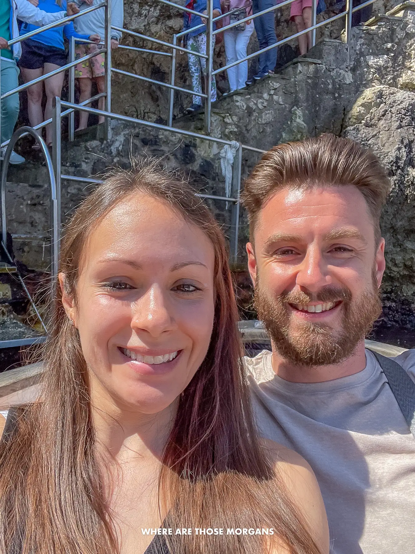Photo of Mark and Kristen from Where Are Those Morgans sat in a row boat with a cliff and line of people waiting behind in Capri