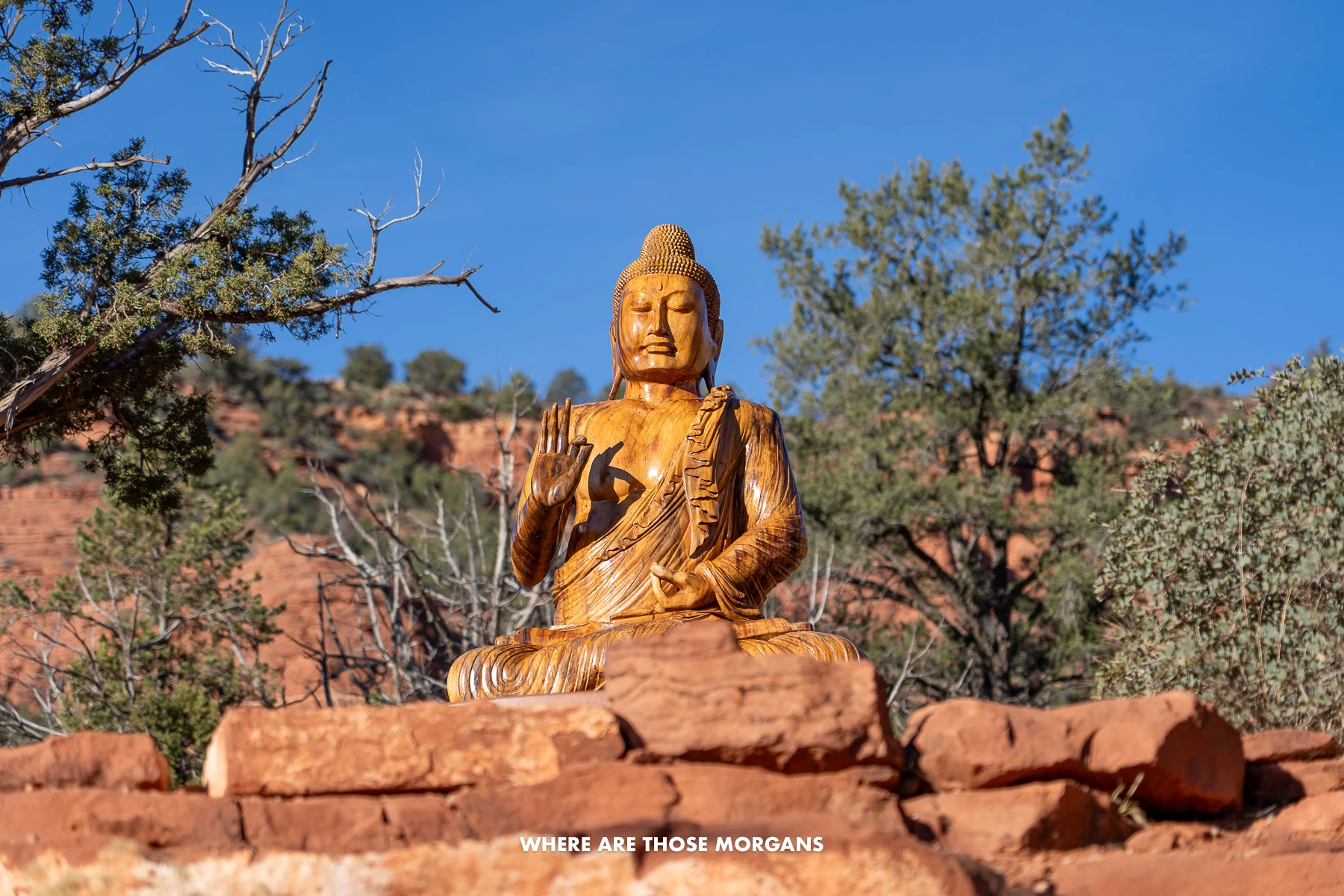 Photo of a large Buddha statue in a red rock park in Arizona