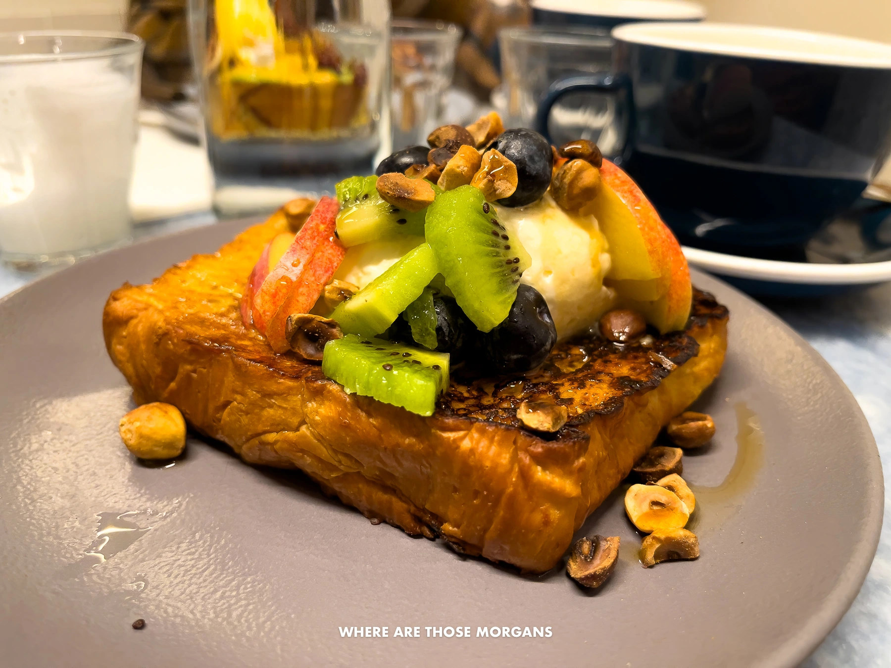 Photo of a plate with french toast and fruit in a brunch restaurant