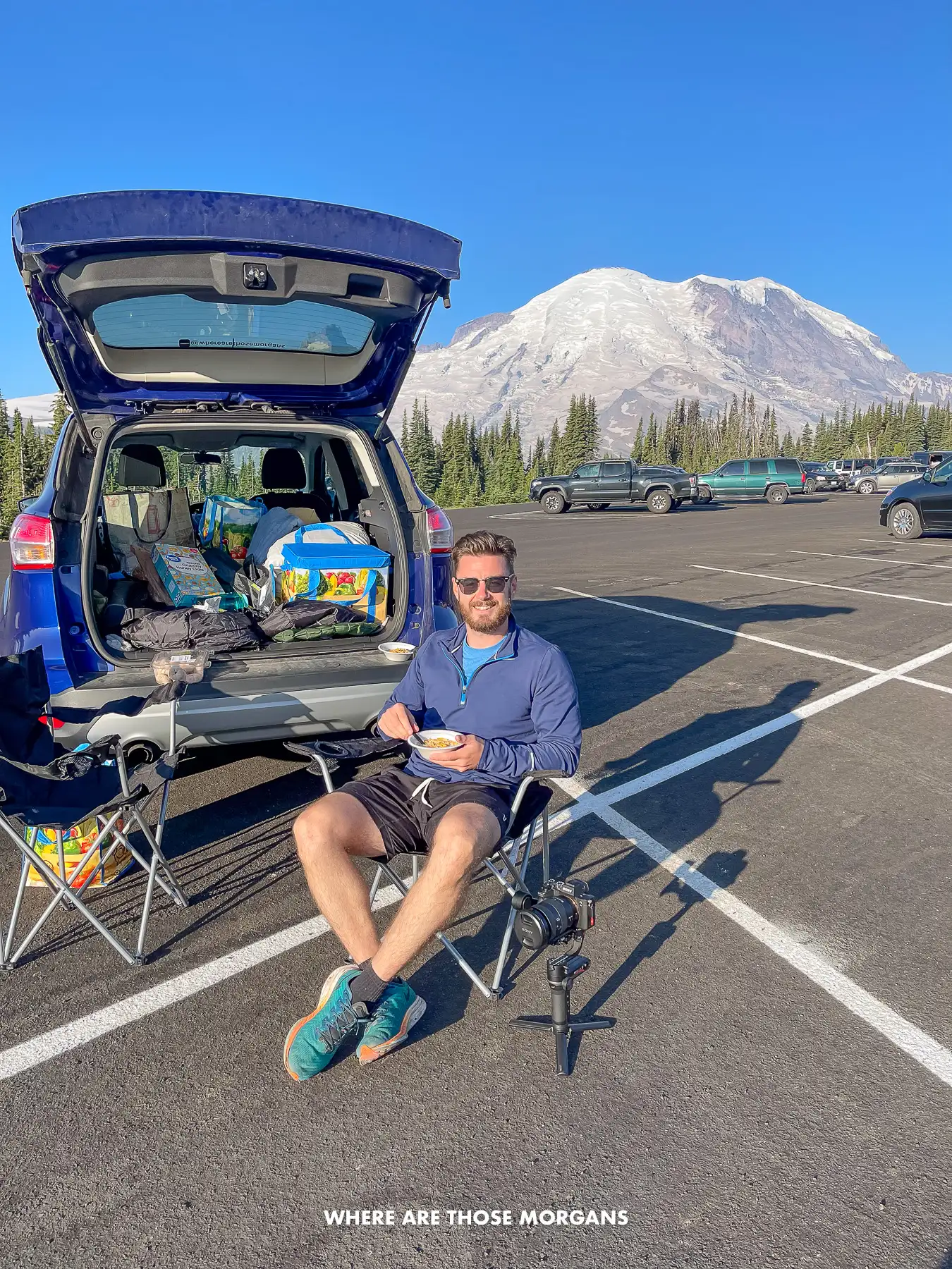 Man eating breakfast and sitting in a camp chair