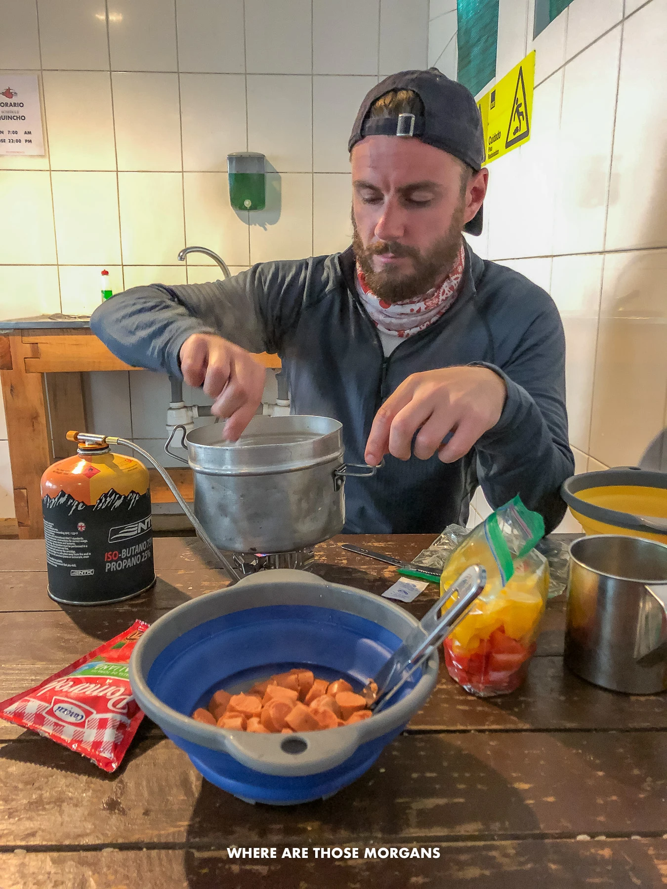 Man cooking a meal over a small stove in Patagonia Chile
