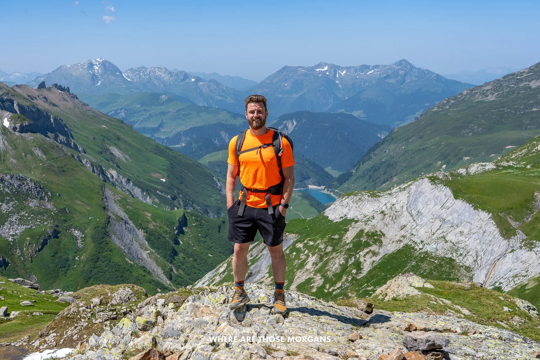 Man posing for a photo on a section of the tour du Mont Blanc