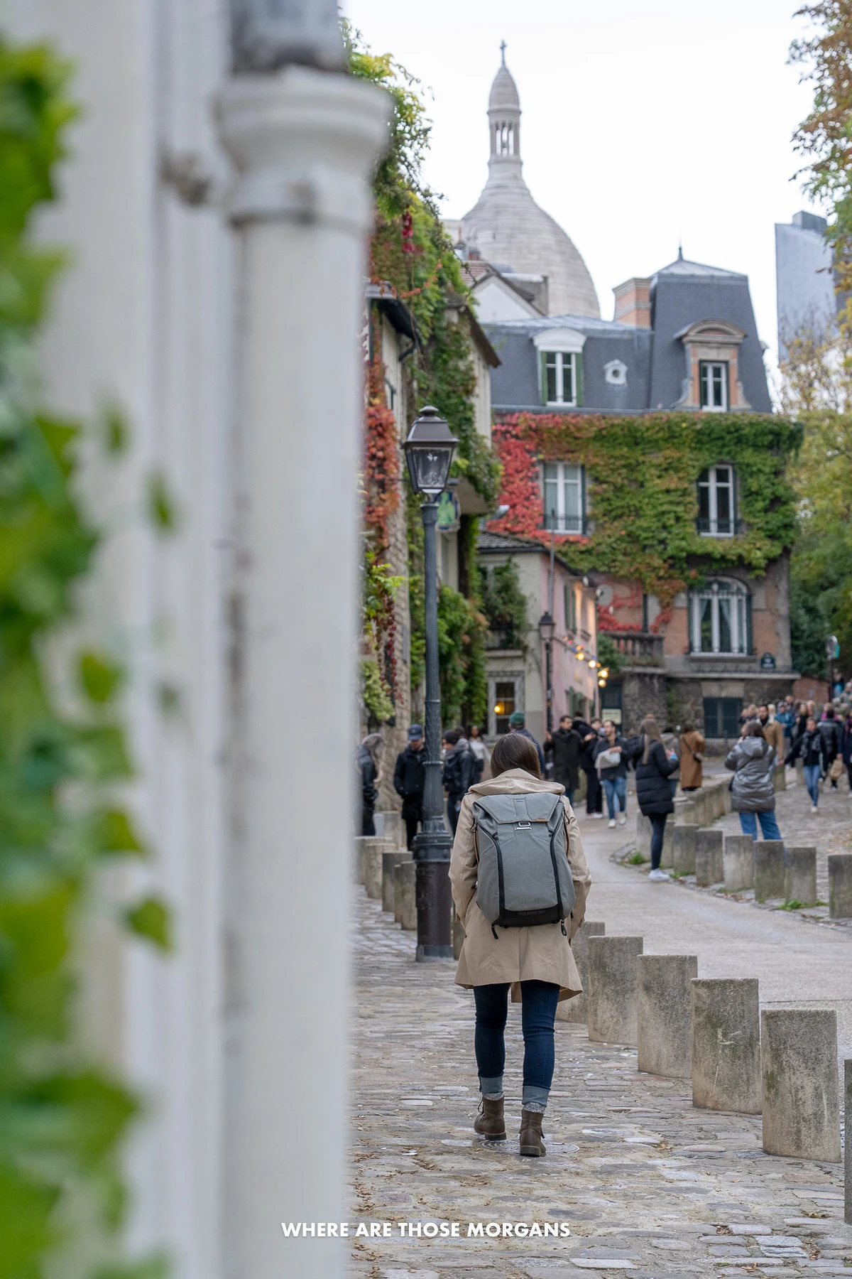 Photo of Kristen Morgan walking through the streets of Montmartre in Paris on a cold day