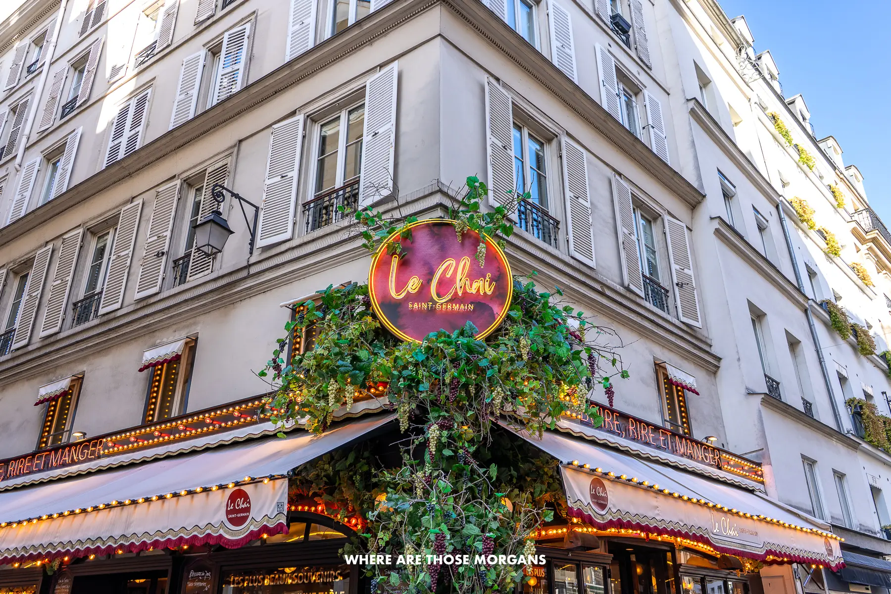Photo of a restaurant with led lights in on the corner of a tall building in Saint Germain, Paris