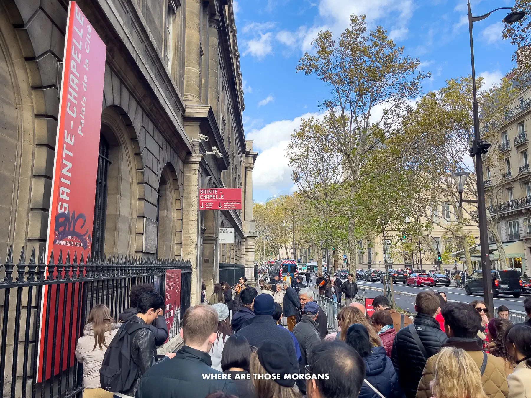 Photo of a line of frustrated tourists waiting to go inside a museum in Paris