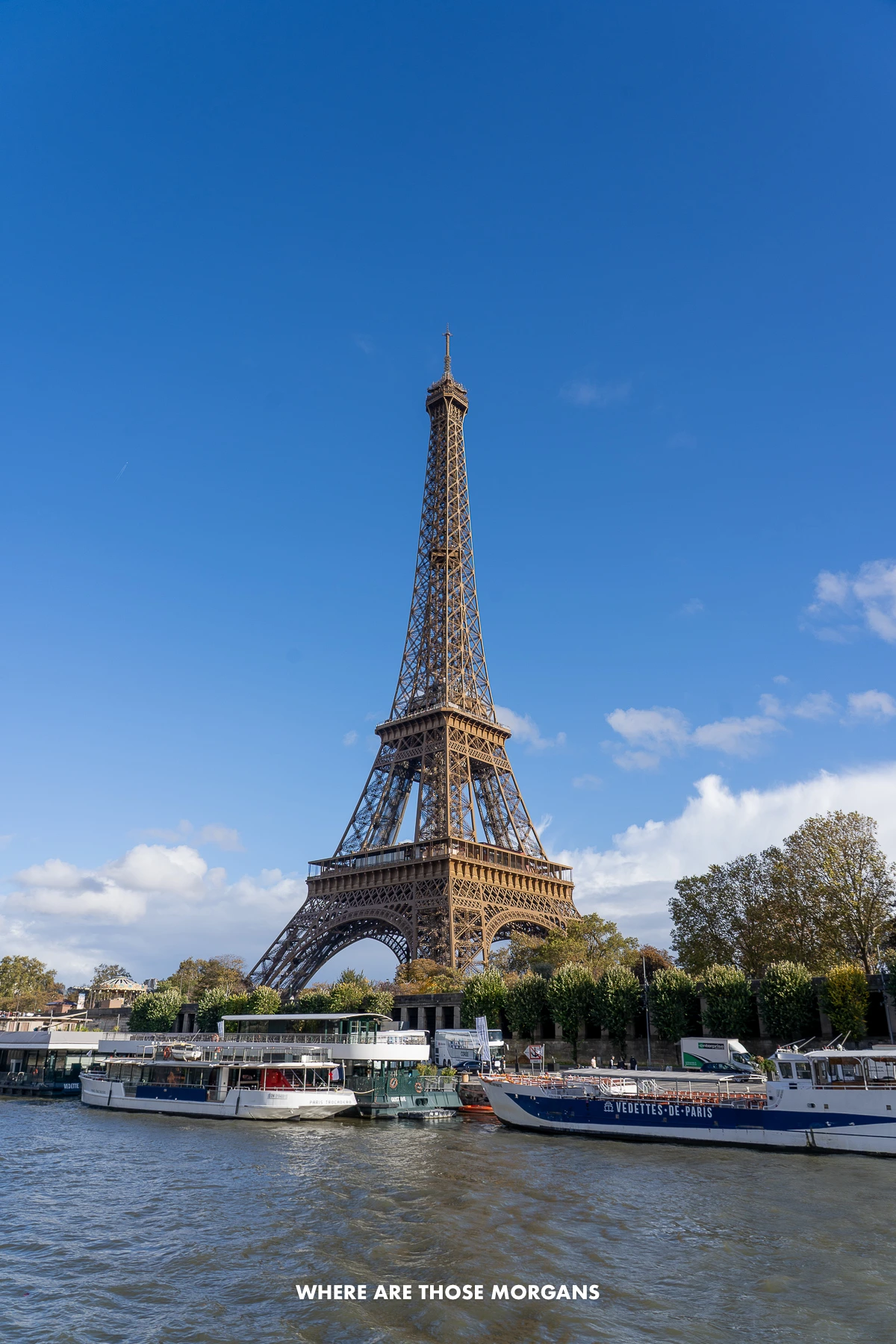 The Seine with boats and Eiffel Tower behind on a clear sunny day
