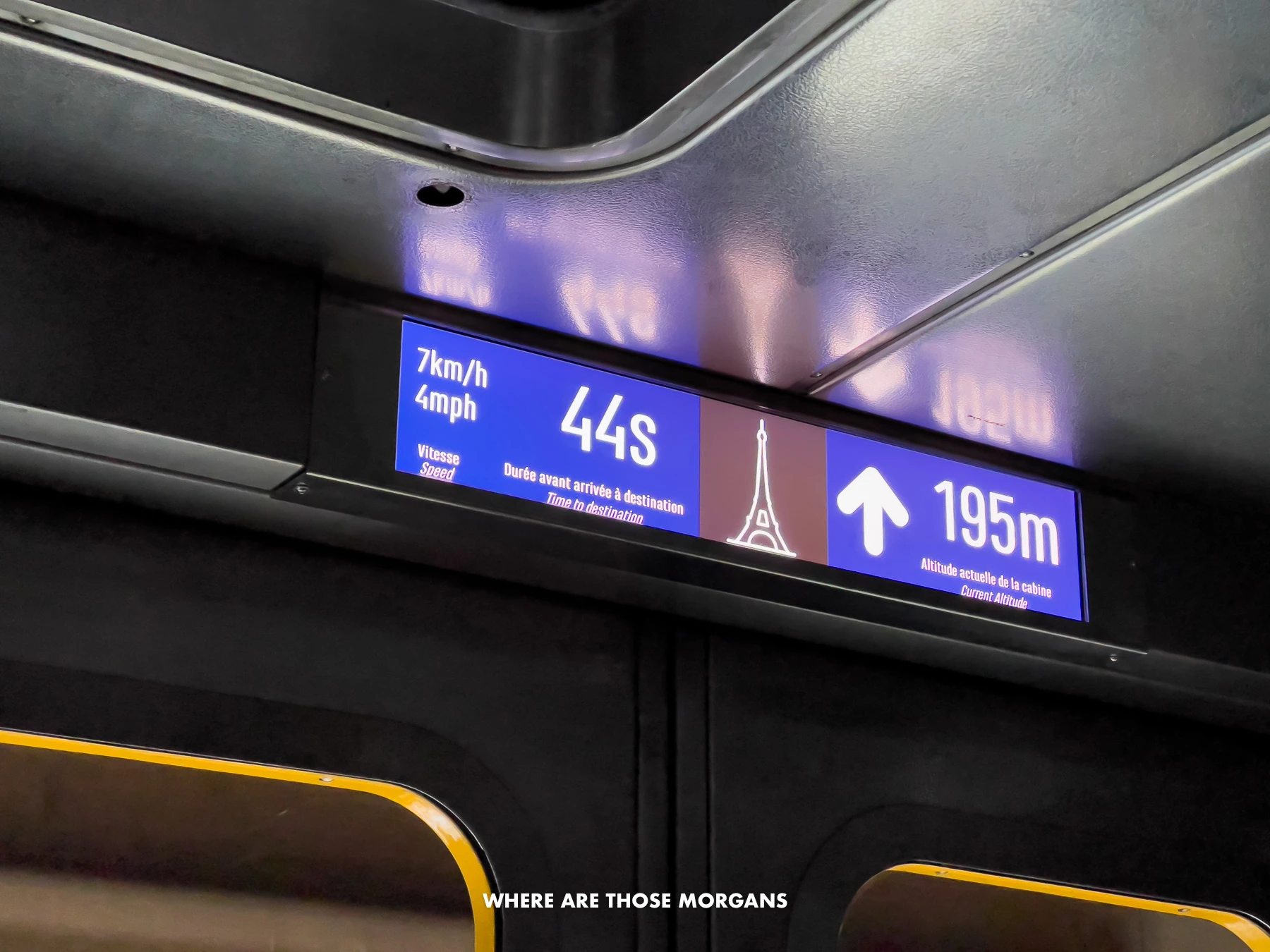 Inside the Eiffel Tower lift looking at the floor and speed of the elevator ascent