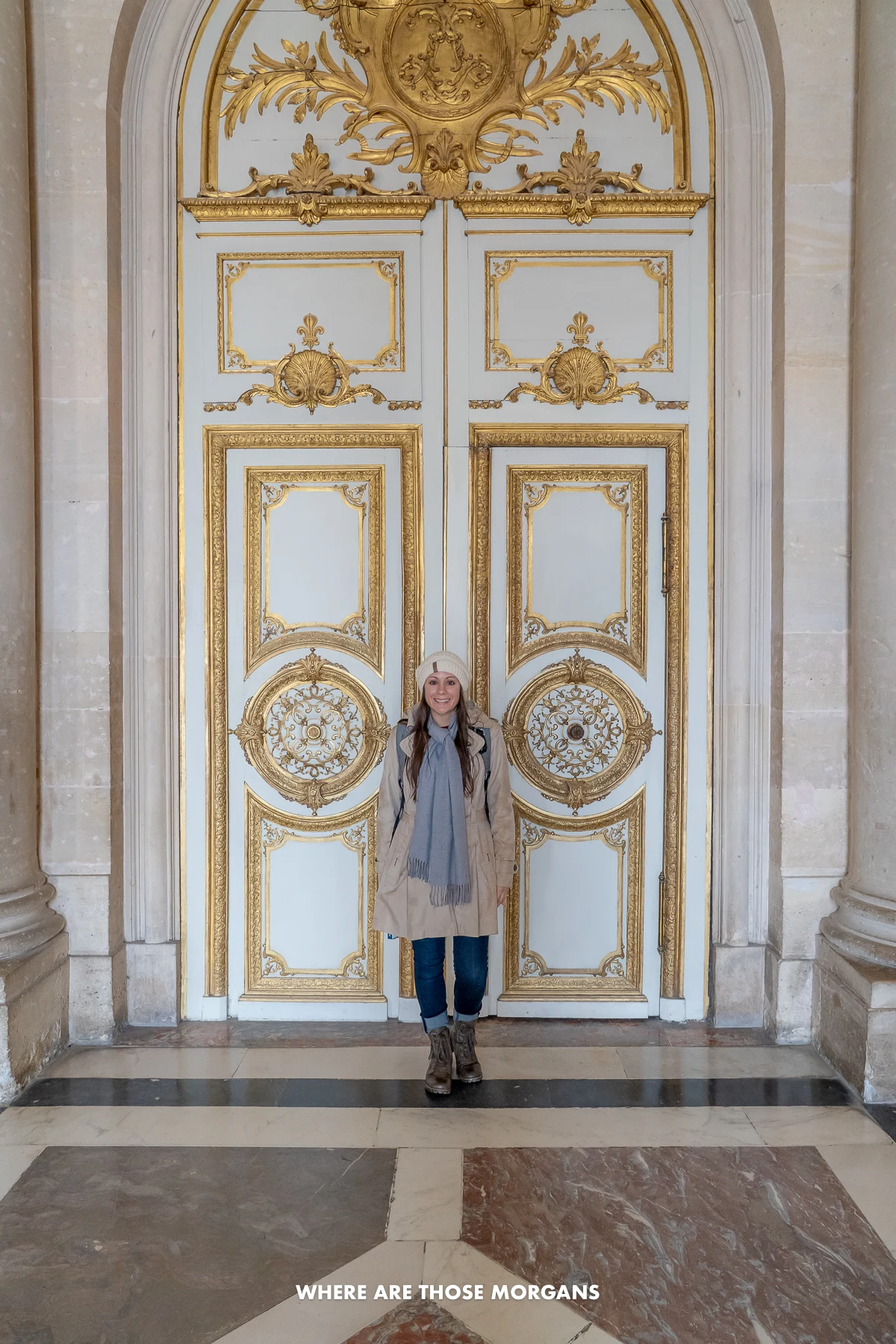 Kristen from Where Are Those Morgans standing against a massive gold adorned door at the Palace of Versailles