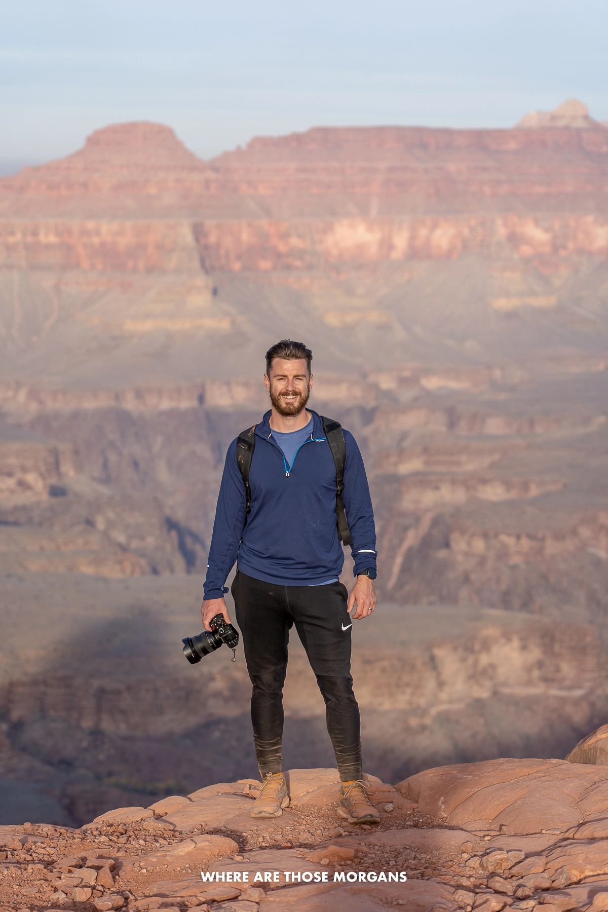 mark morgan grand canyon Mark Morgan holding camera with a view overlooking the Grand Canyon on a sunny day