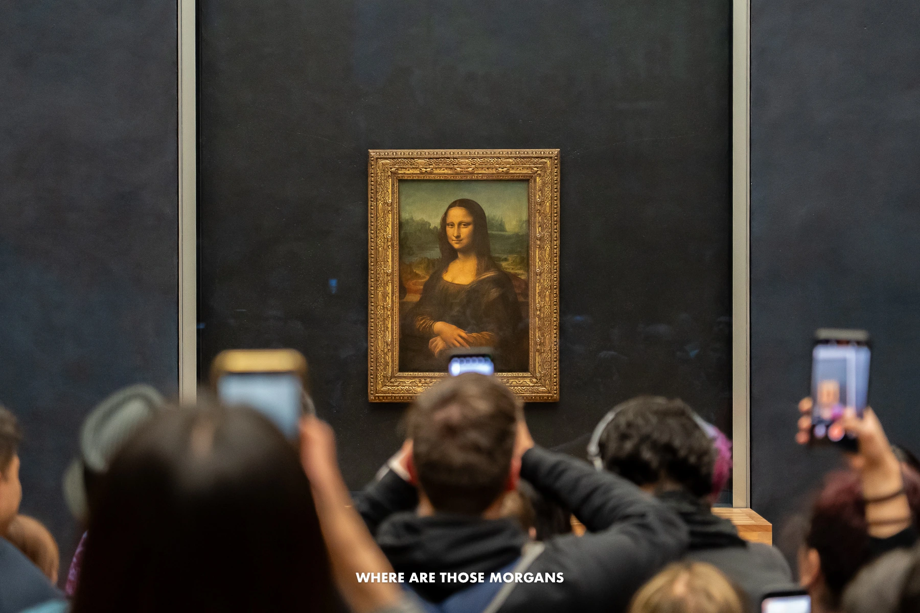 Photo of people taking photos of the Mona Lisa painting with smartphones being held up