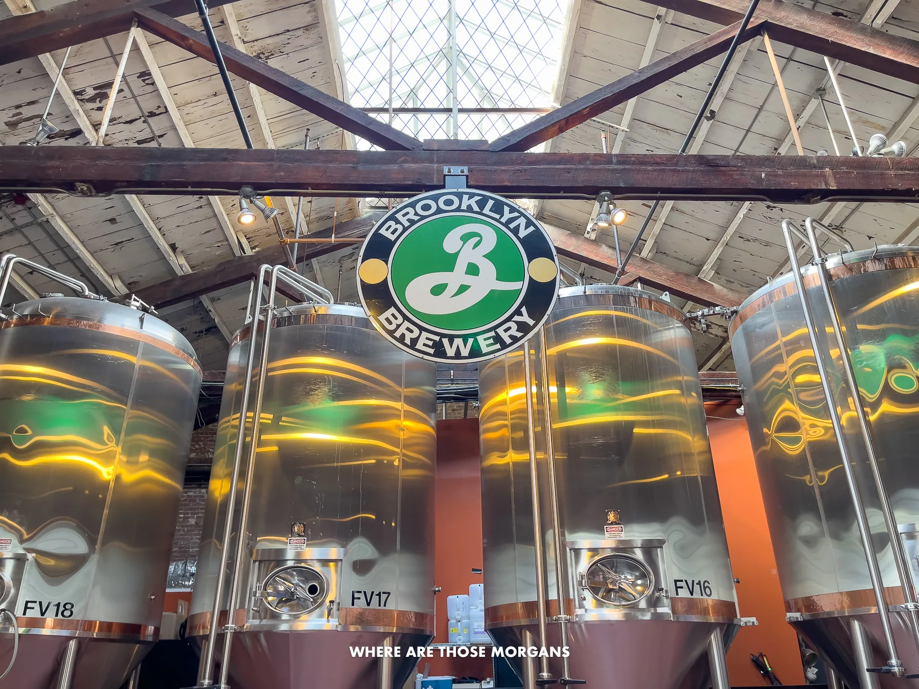 Four big brewing tanks in a warehouse building with a small Brooklyn Brewery logo above