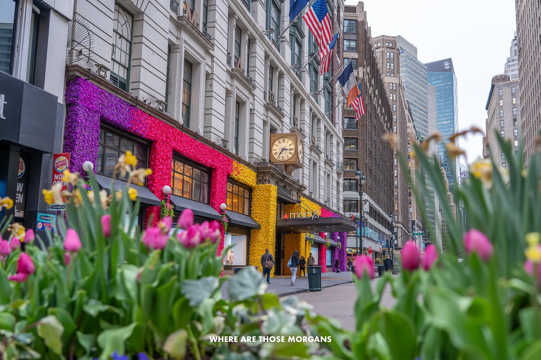 Exterior of Macy's Herald Square in NYC with flowers in spring