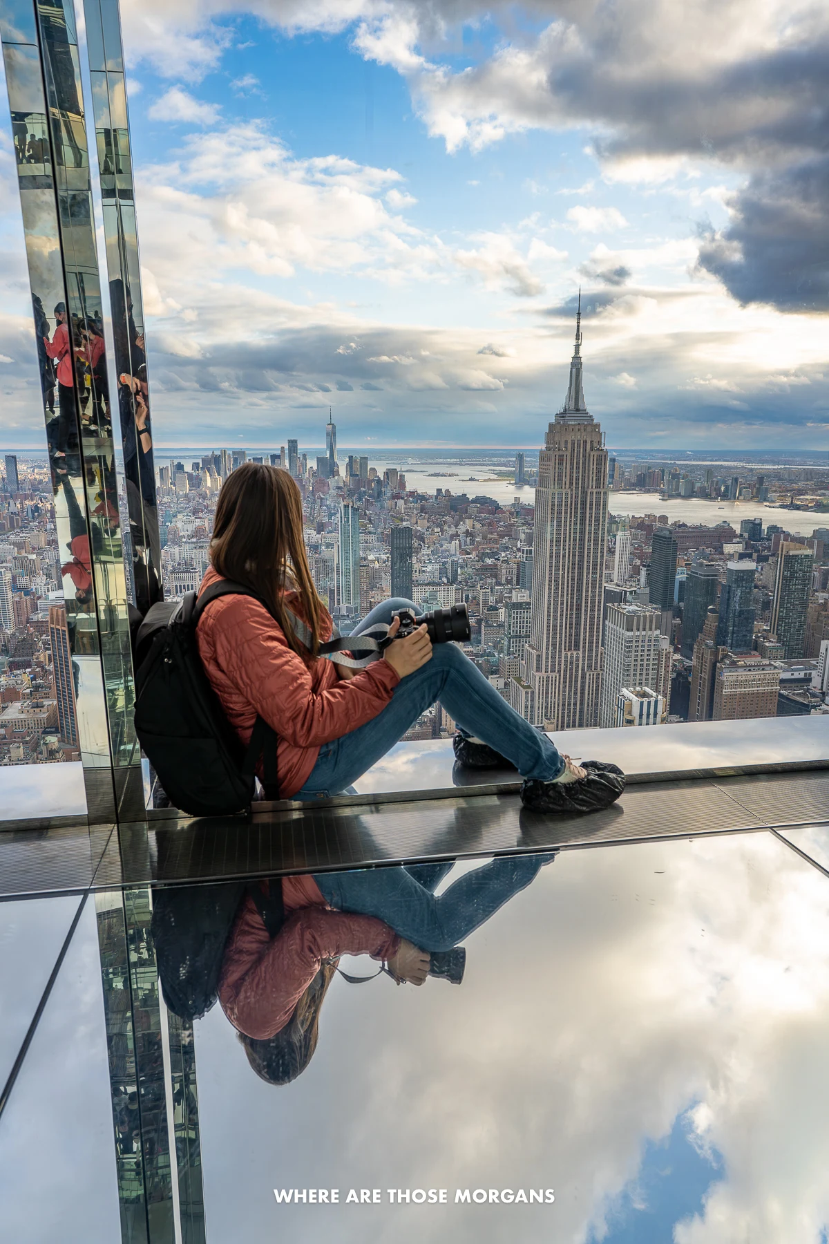 Kristen from Where Are Those Morgans looking out at NYC from an observation deck with mirrored rooms